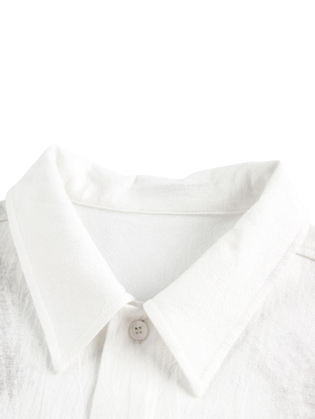 Close-up of TALISHKO's white shirt collar, showcasing fine texture and stitching details.