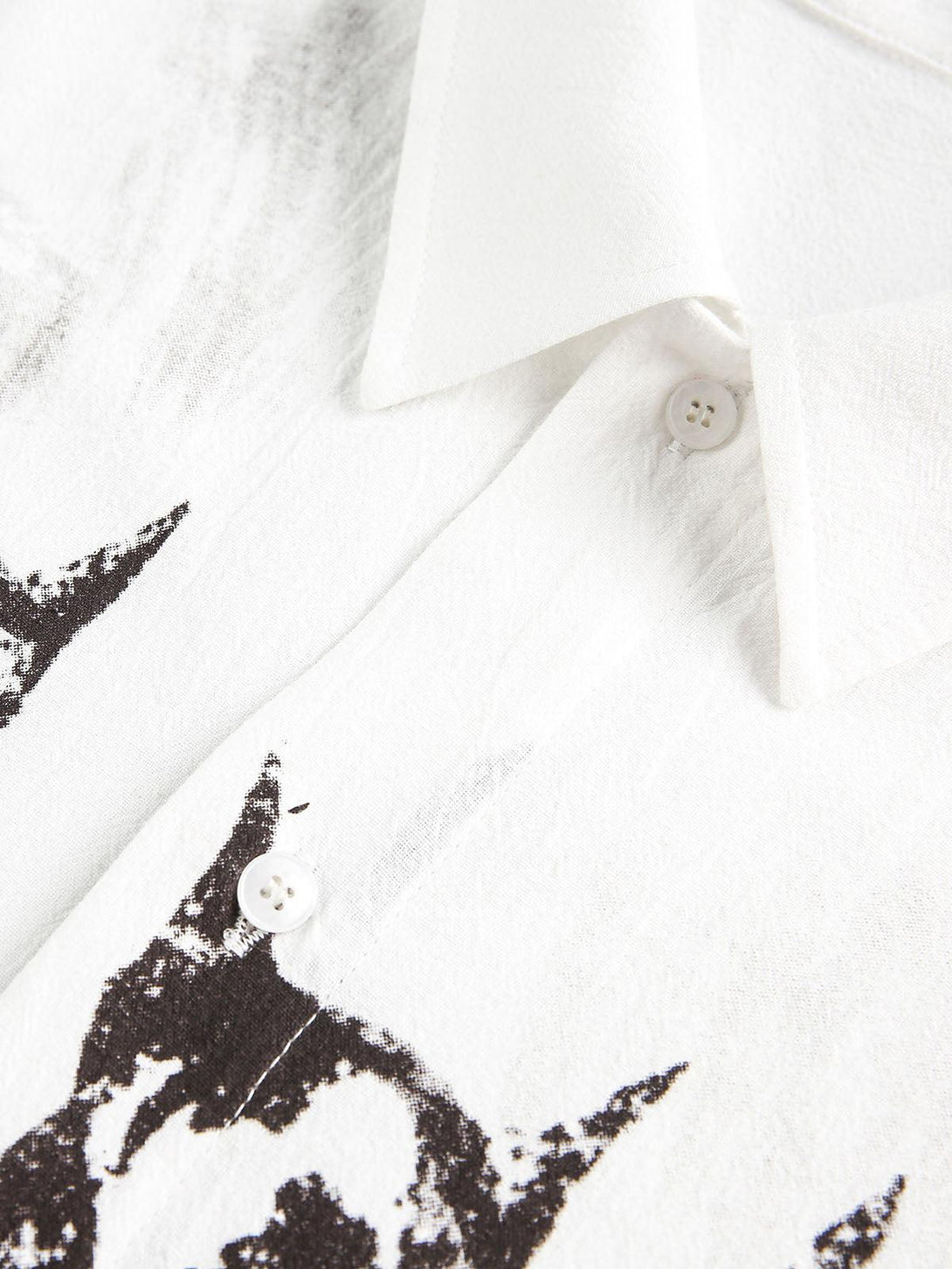 A close look at TALISHKO's white shirt buttons and Doberman print, emphasizing texture details.