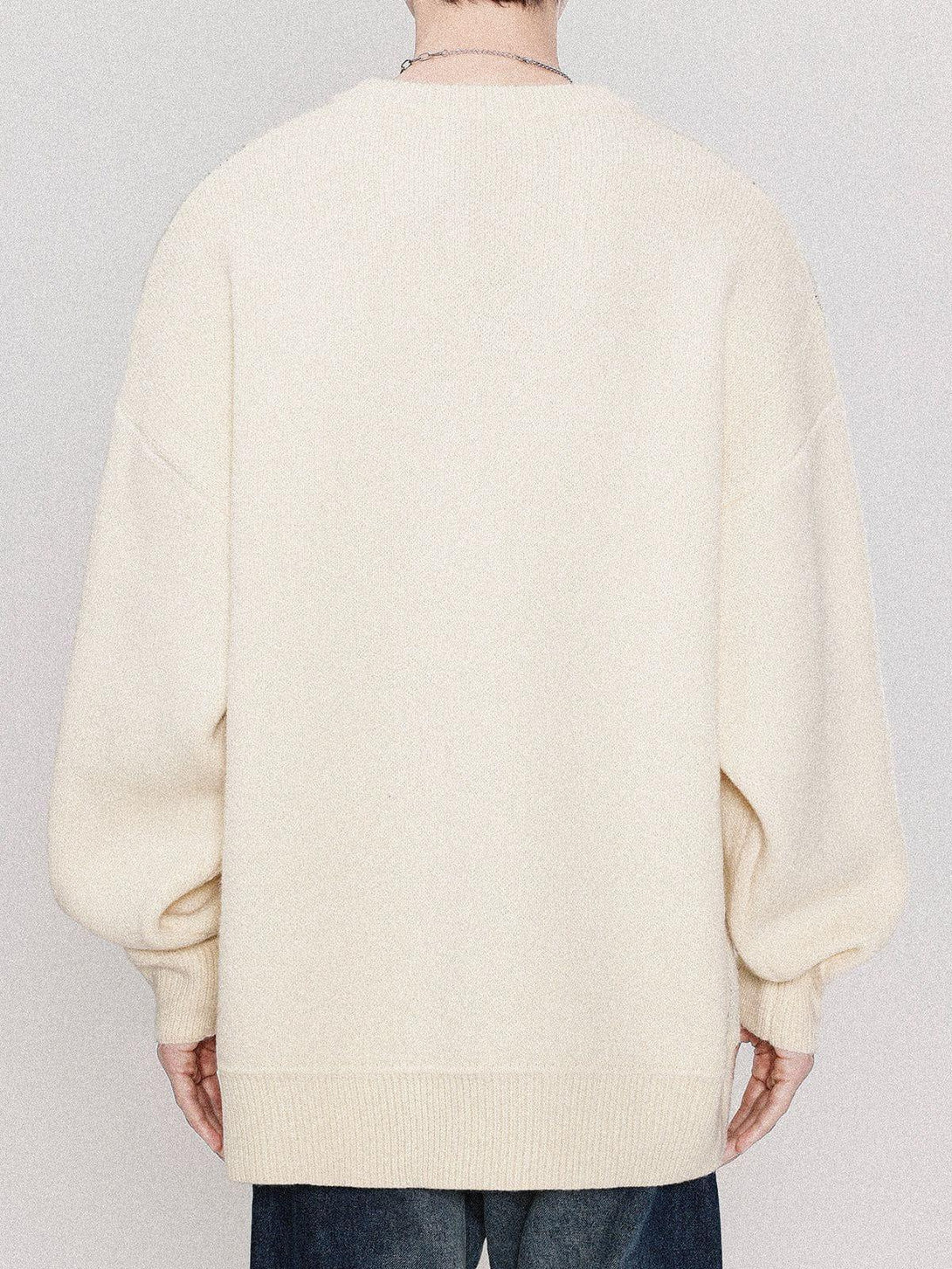 Back view of cream sweater by TALISHKO, showcasing a relaxed fit and cozy material.