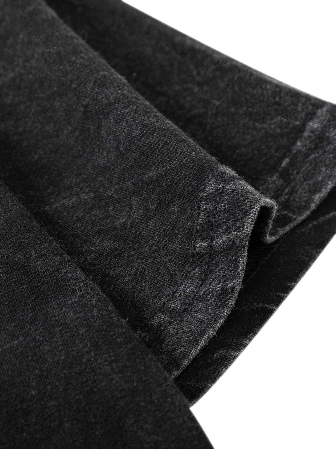 A detailed view of TALISHKO's washed black t-shirt fabric, highlighting its soft texture.