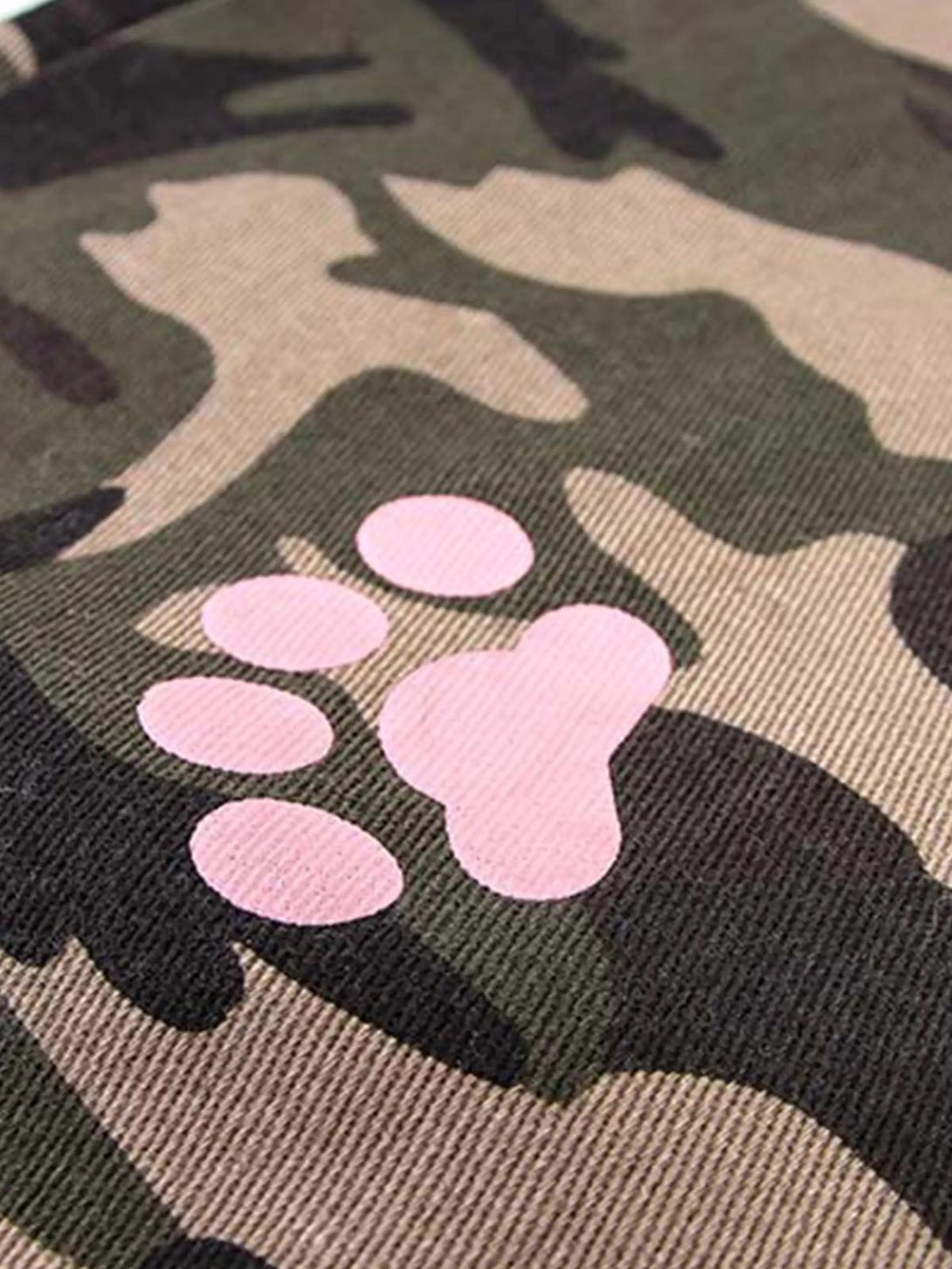 A detailed view of the playful pink paw print on TALISHKO camouflage pants fabric.