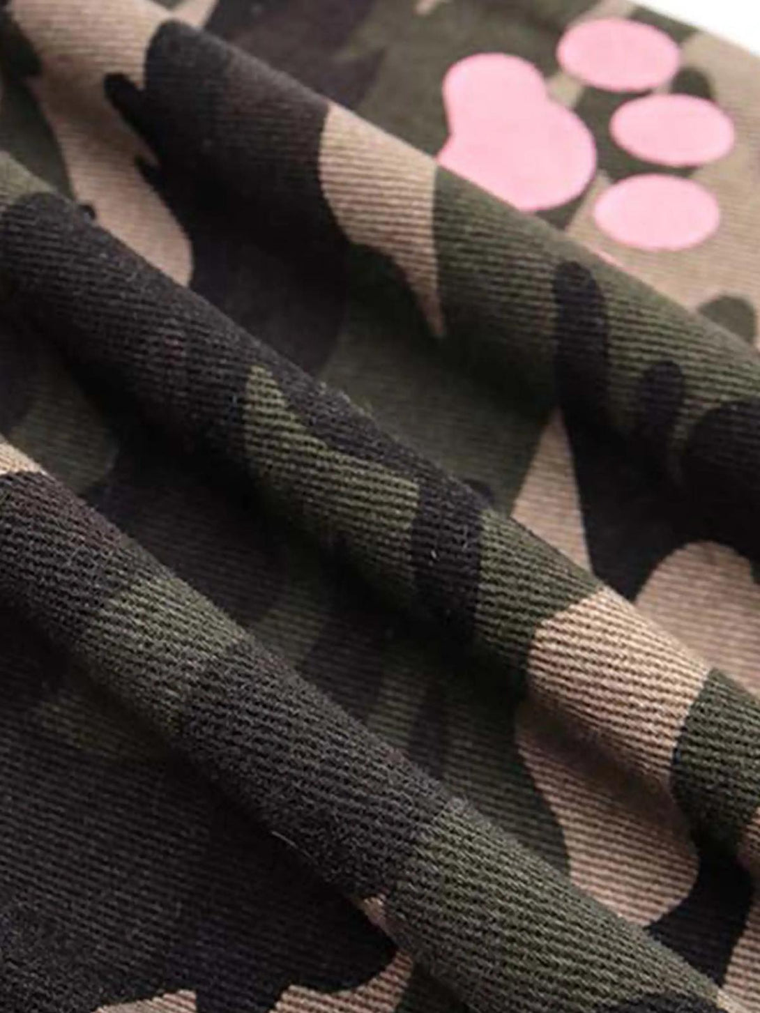 A close-up of TALISHKO's camouflage pants, highlighting the pink paw print detail.