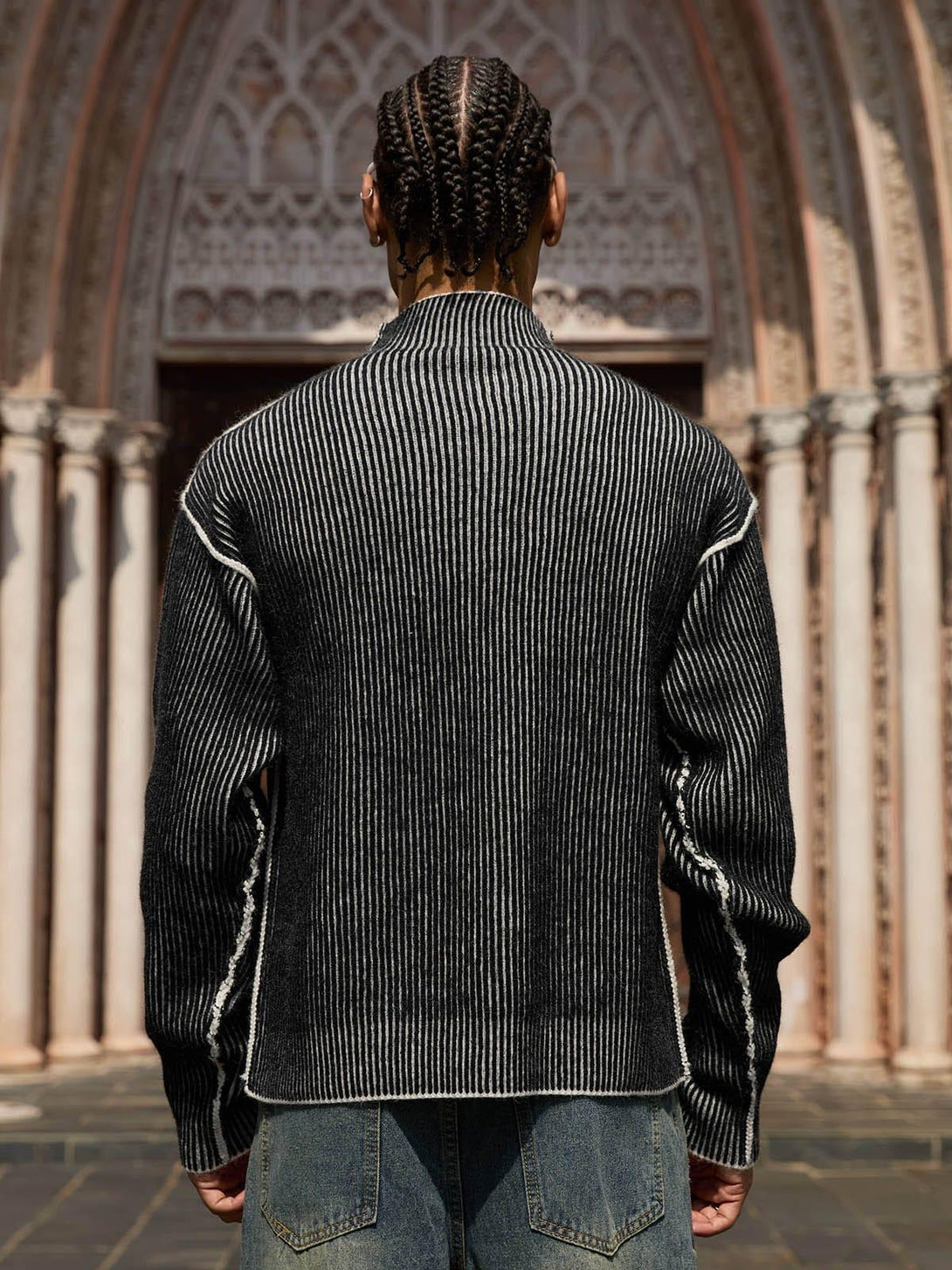 Model wearing a TALISHKO sweater from the back, highlighting the textured knit design.