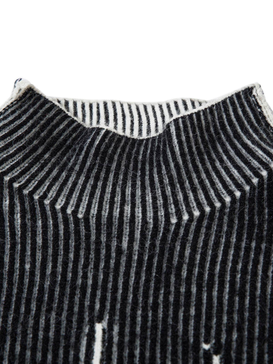 Focusing on the ribbed texture of TALISHKO's sweater, showcasing detailed striped design.