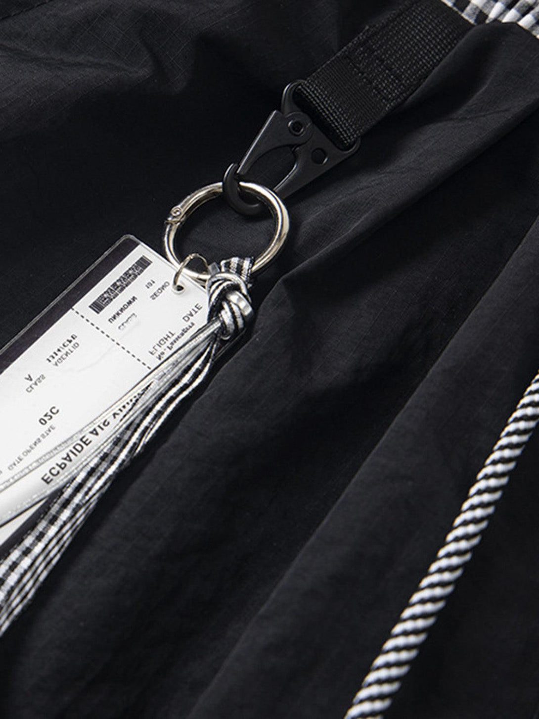 Intricate look at the double waist design on black cargo pants by TALISHKO.