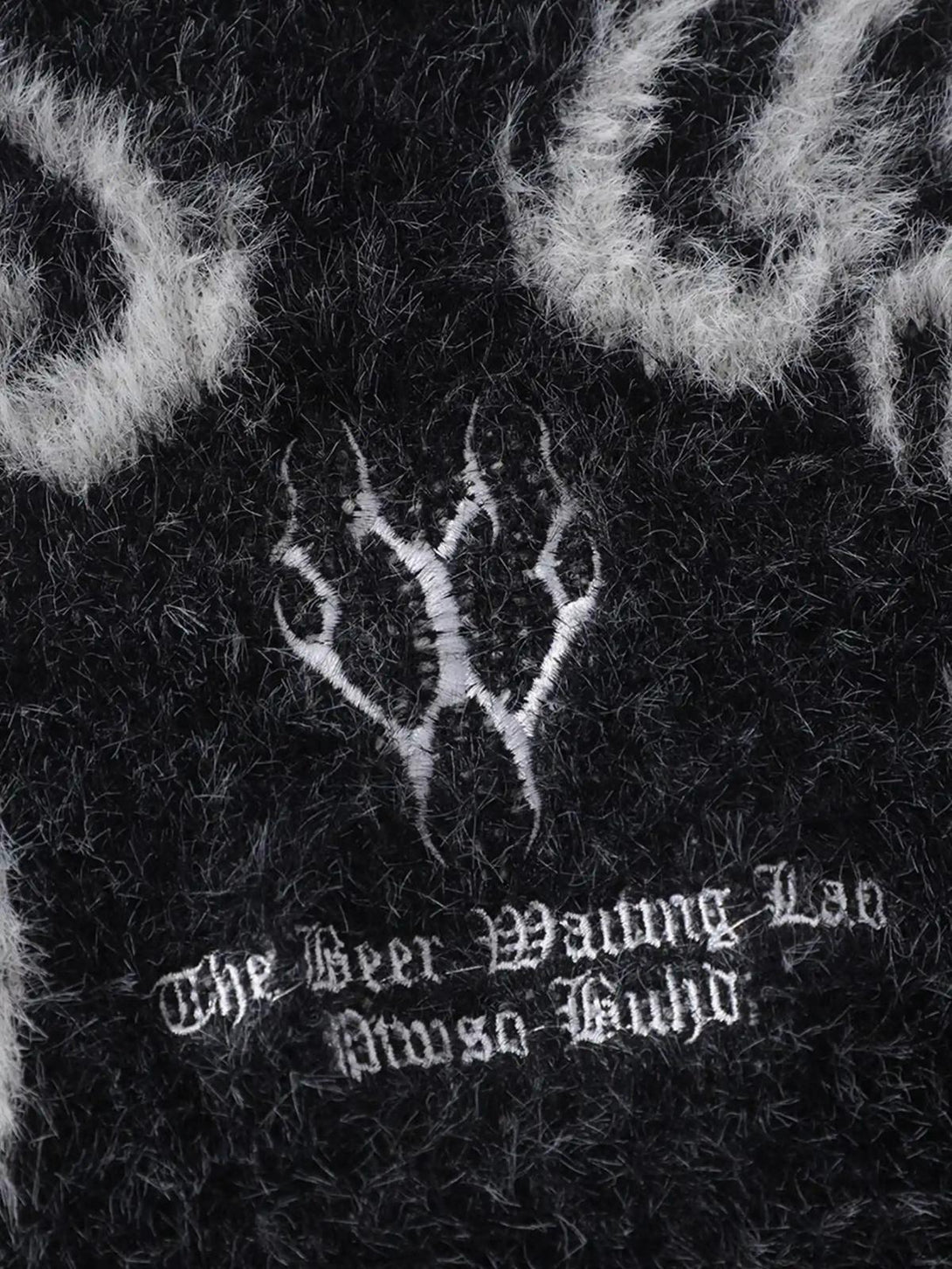 Intricate look at the fuzzy texture and design details of the Dragon Mohair Jacquard Sweater by TALISHKO.