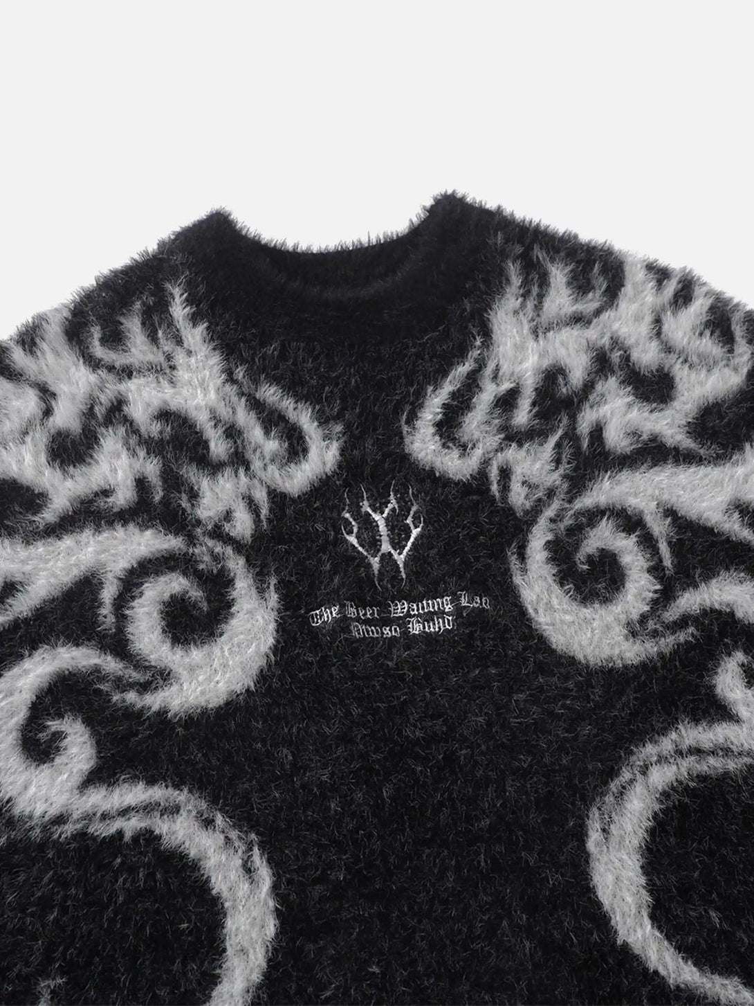 Fuzzy black and white mohair sweater by TALISHKO, featuring intricate swirling patterns.