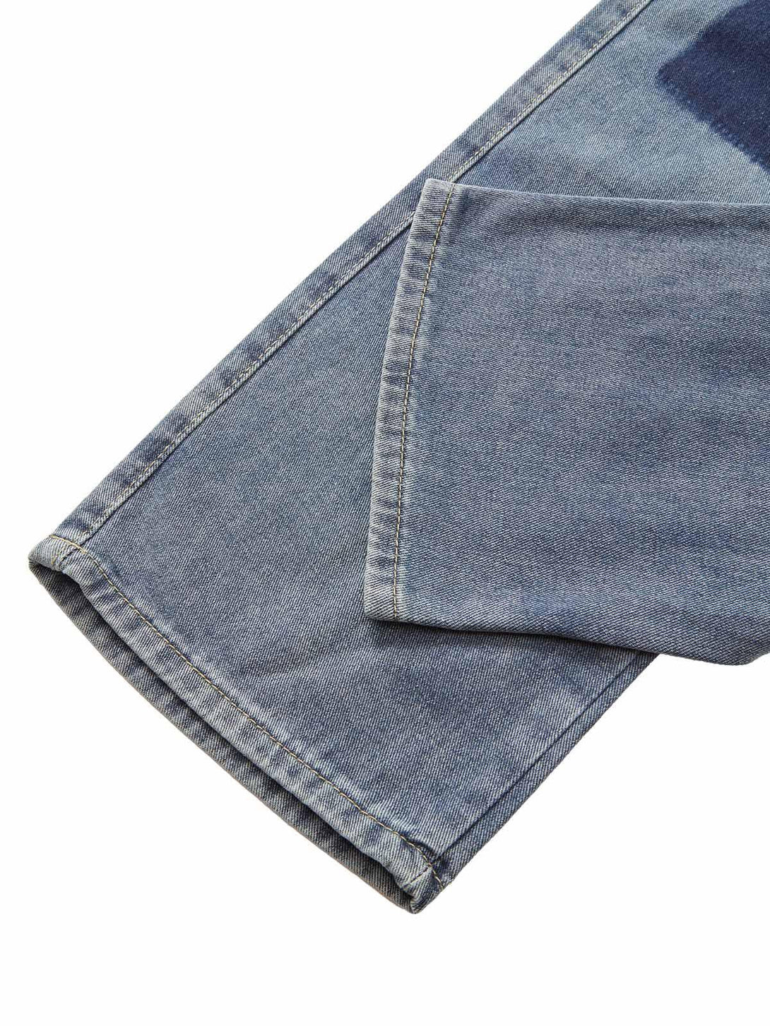 A tight crop highlighting the hem and stitching details on TALISHKO drawstring denim jeans.