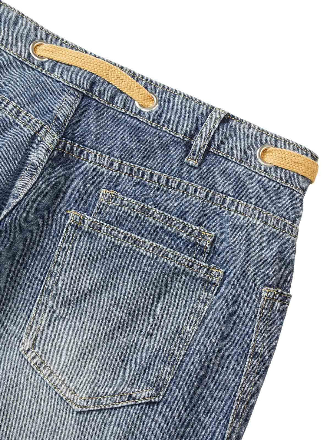 Detailed view of TALISHKO jeans' back pocket, highlighting the yellow drawstring and stitching.