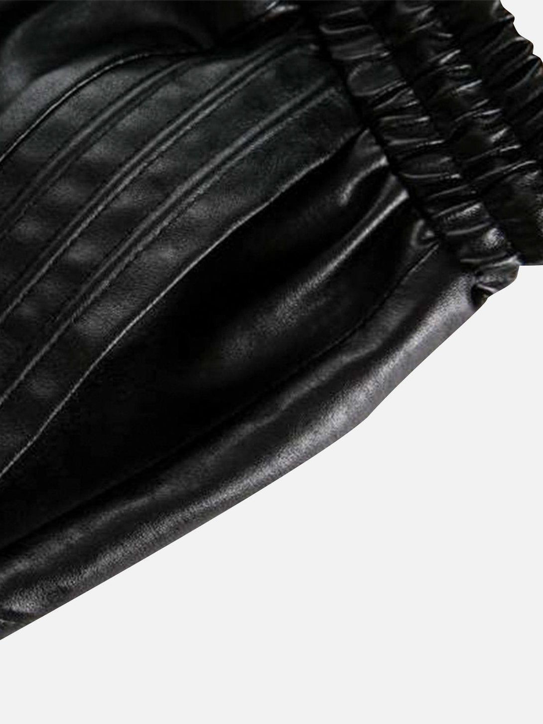 A detailed view of TALISHKO's drawstring faux leather shorts, highlighting the sleek texture.