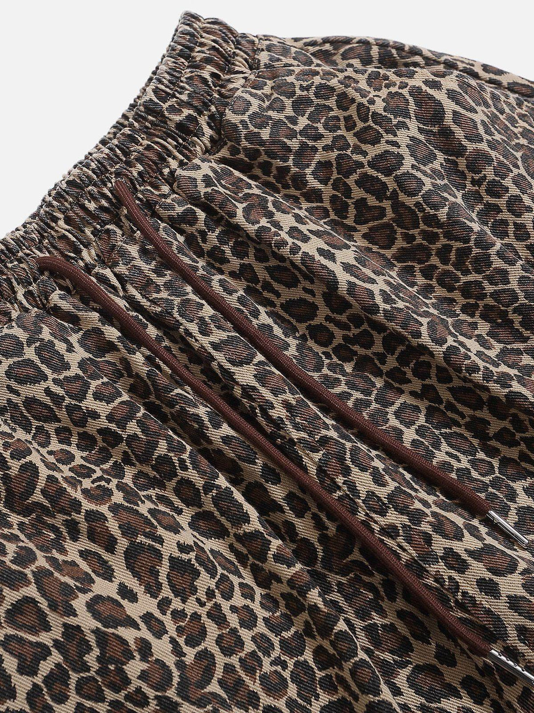 Intricate look at leopard print fabric and drawstring detail on shorts by TALISHKO.