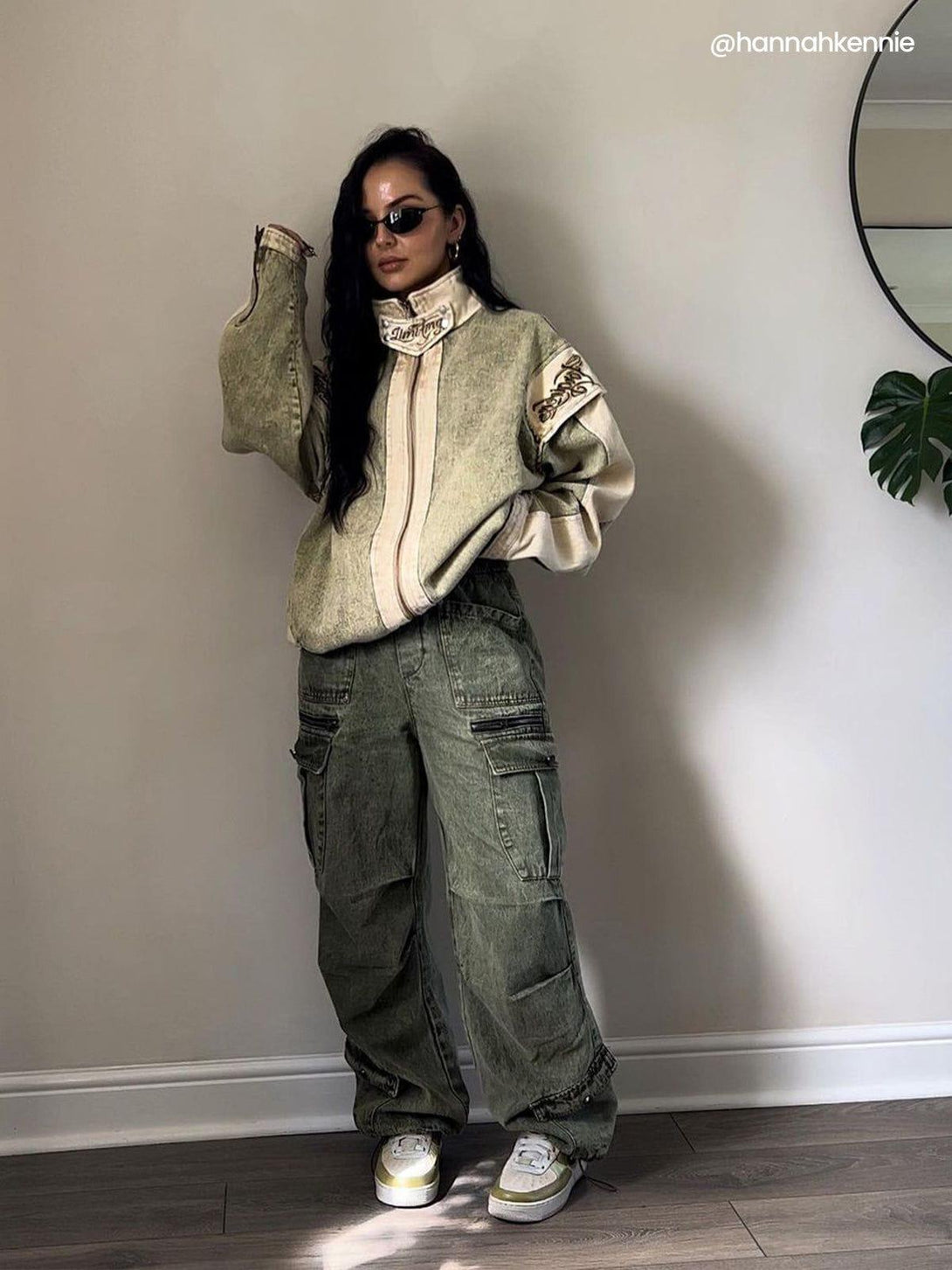 Model wearing oversized jacket and drawstring cargo jeans by TALISHKO, styled with sporty sneakers.