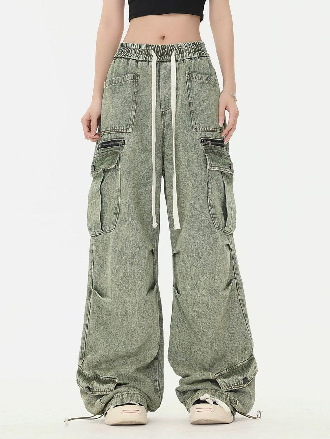 Model showcasing TALISHKO drawstring cargo jeans with a relaxed fit and multiple pockets.