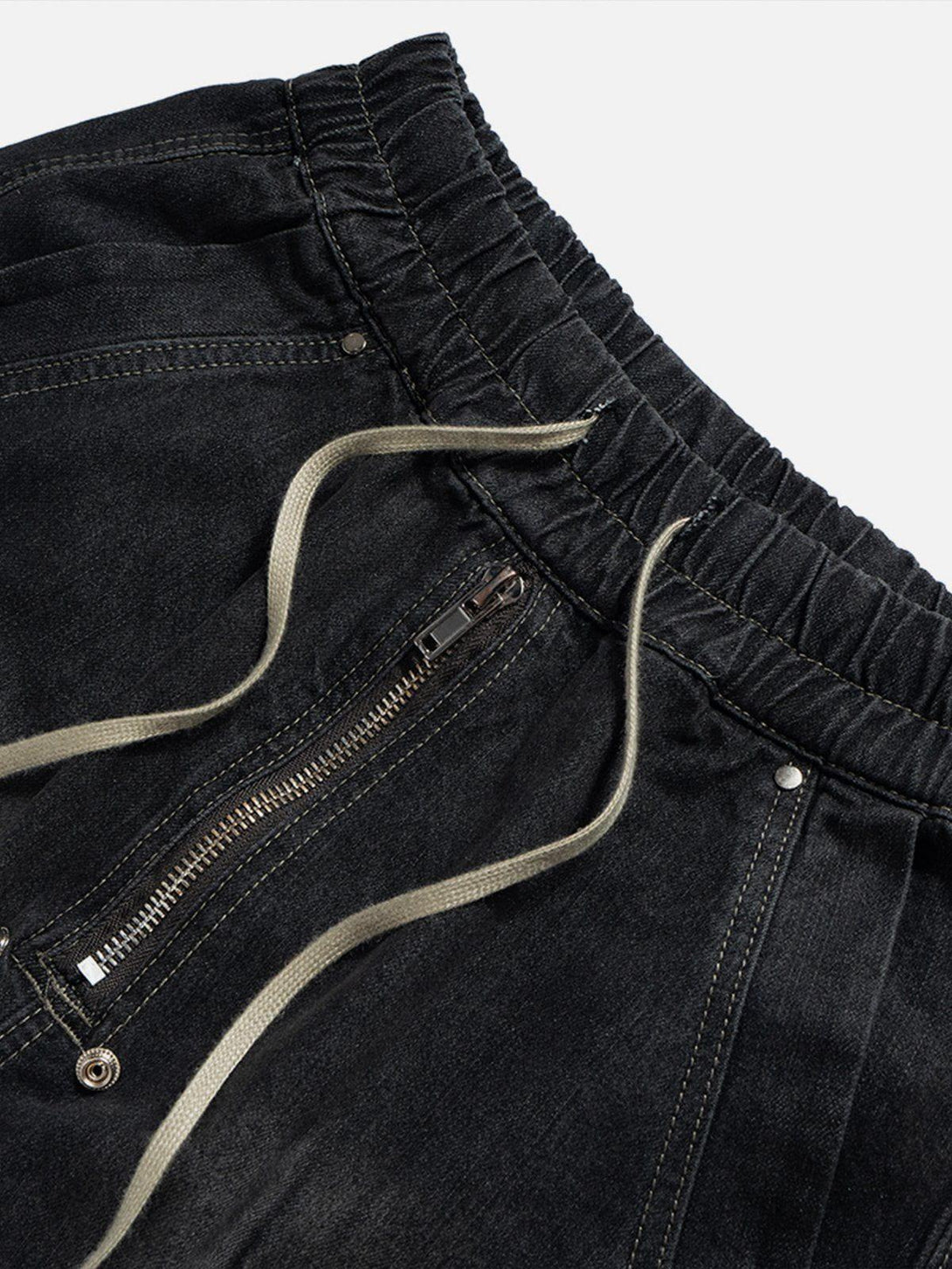 Intricate look at TALISHKO's drawstring washed jorts, highlighting zipper and stitching details.