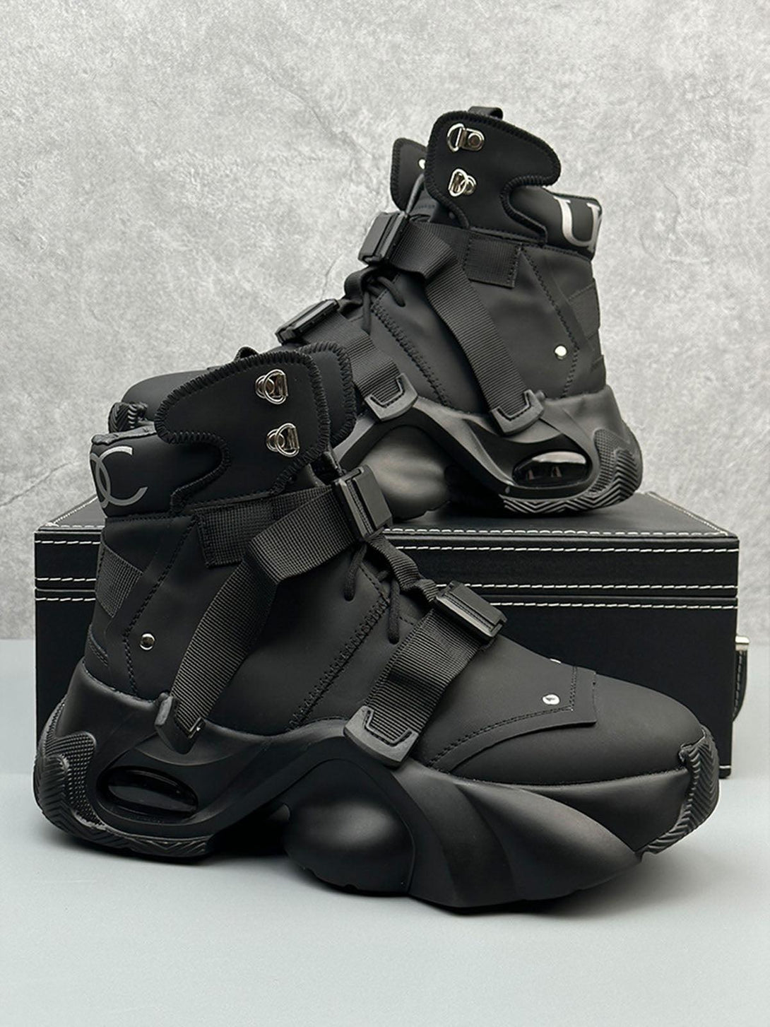 Sleek black dual-strap boots by TALISHKO, featuring a modern design and unique sole structure.