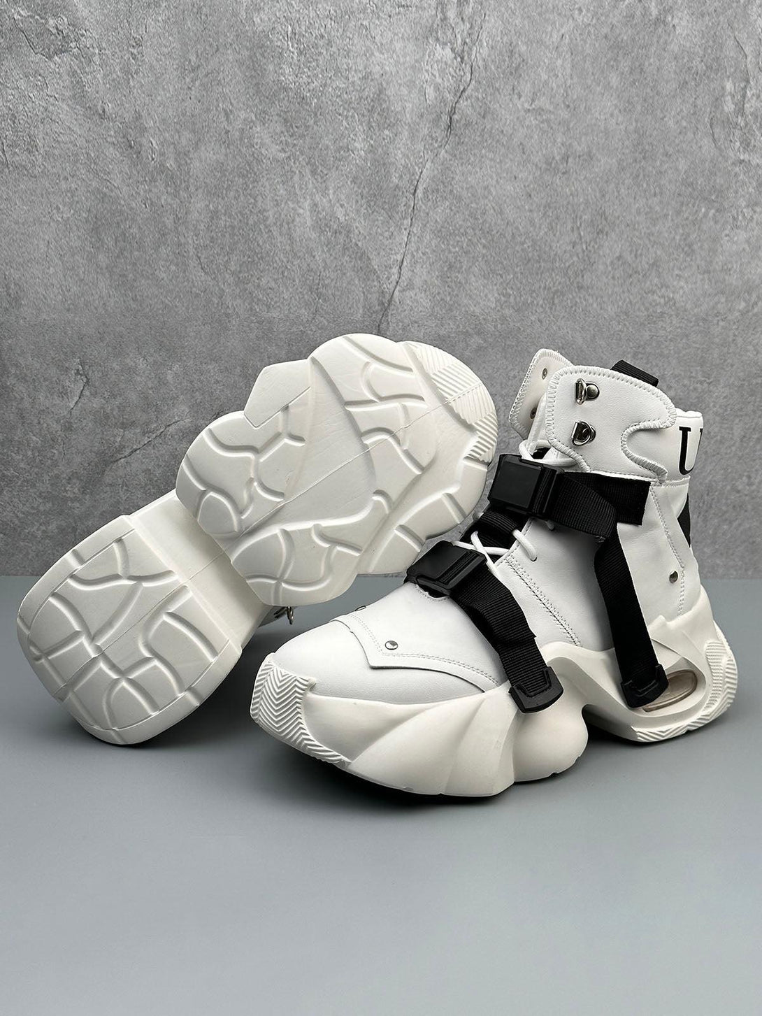 White stealth runner boots by TALISHKO, featuring a bold dual-strap design and chunky sole.