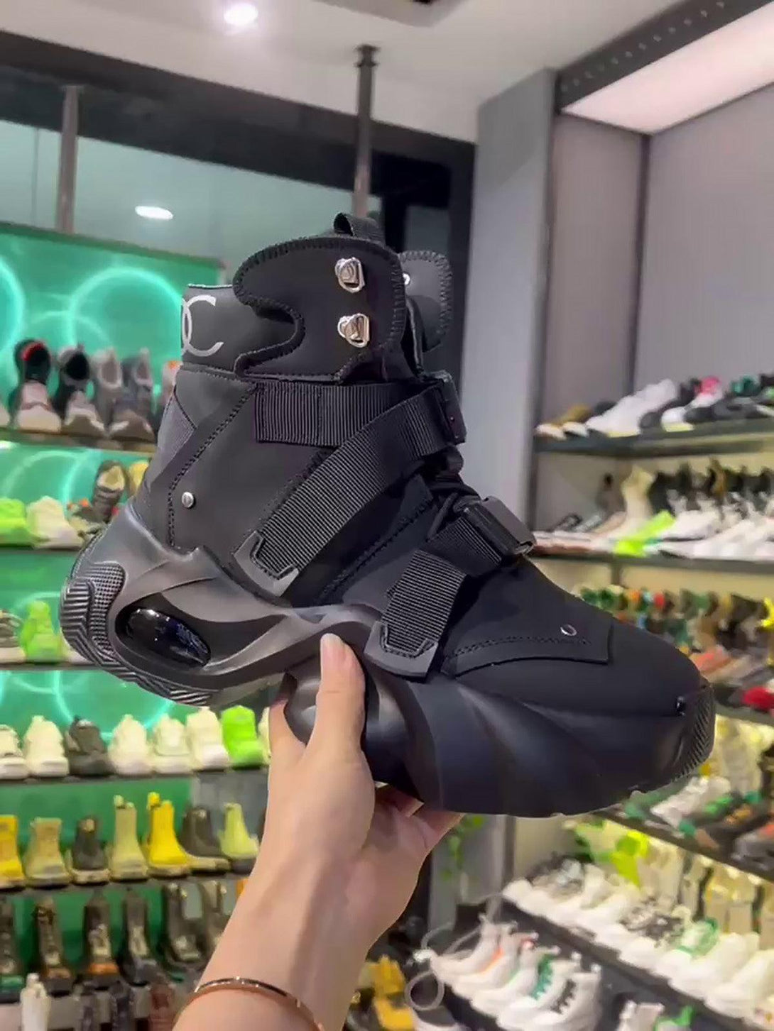 Black stealth runner boots with dual straps by TALISHKO, featuring a bold, futuristic design.