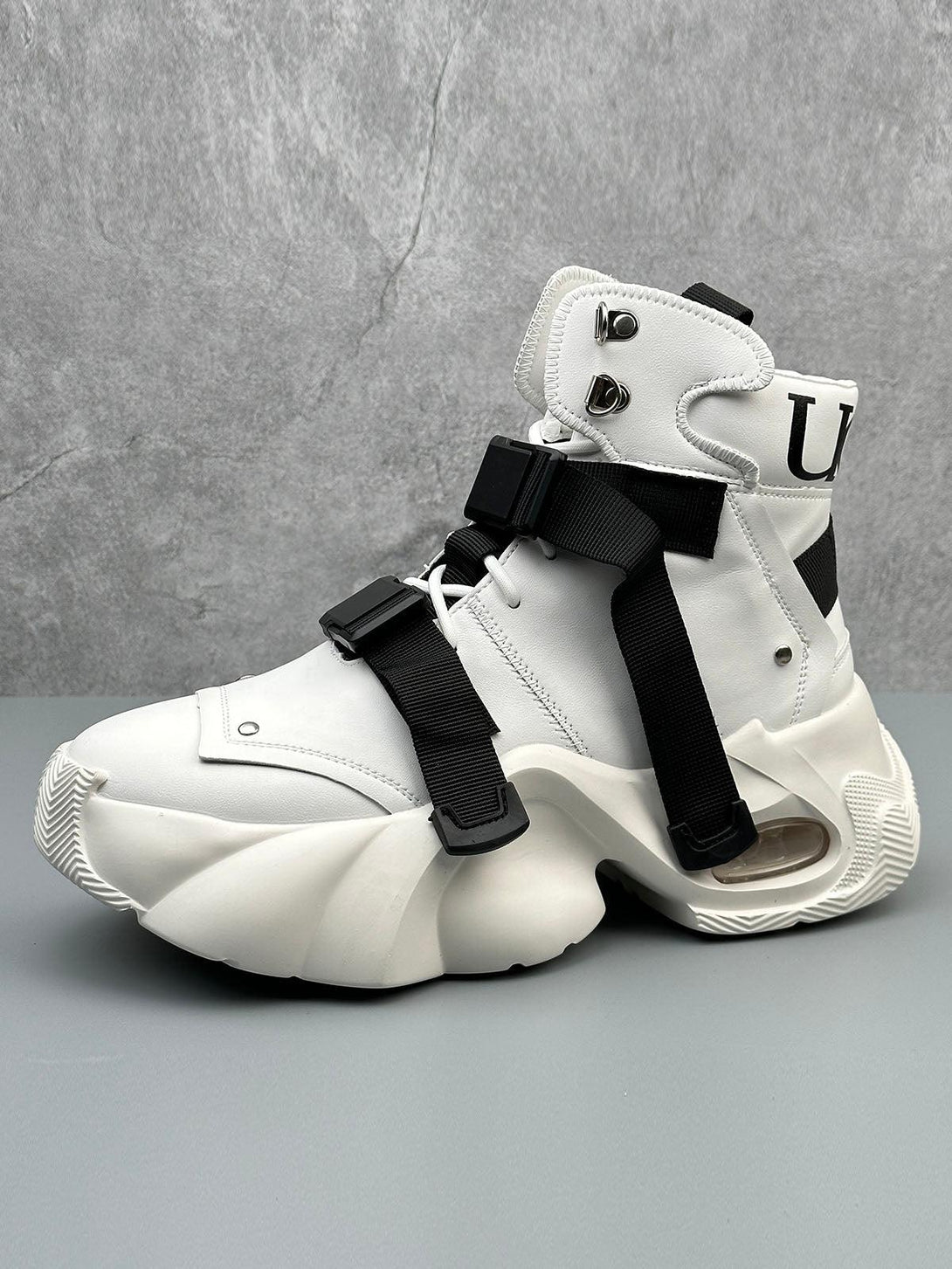 White dual-strap runner boots by TALISHKO, featuring a unique, futuristic design and chunky sole.