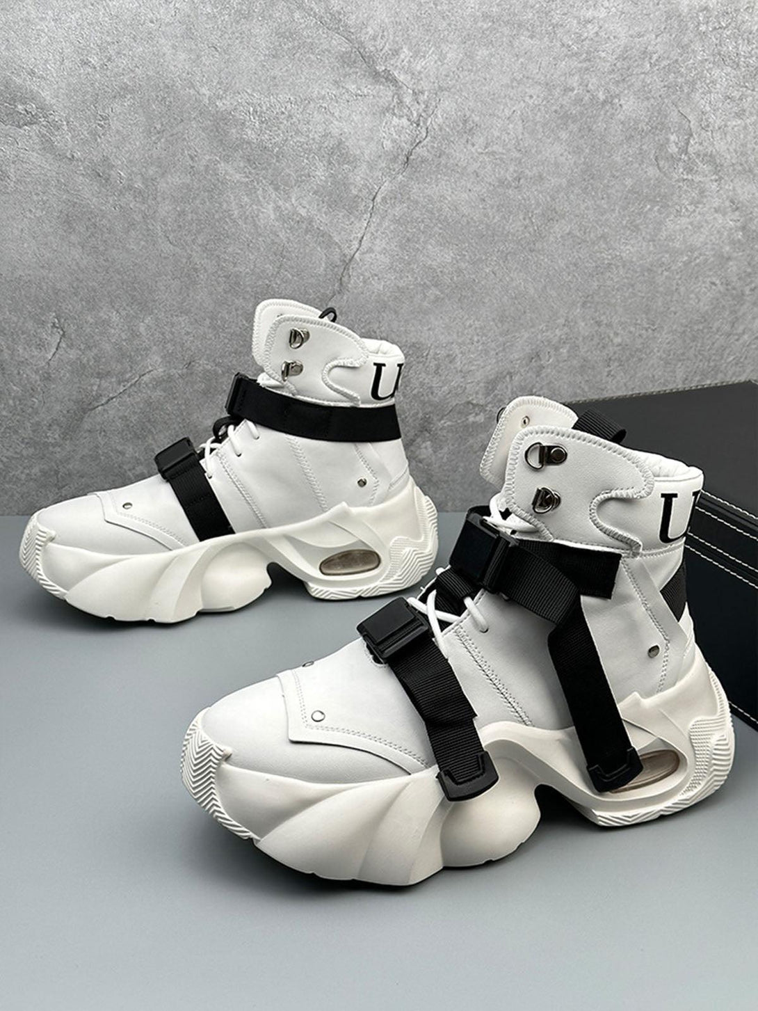 Futuristic white dual-strap boots by TALISHKO, highlighting bold design and chunky soles.