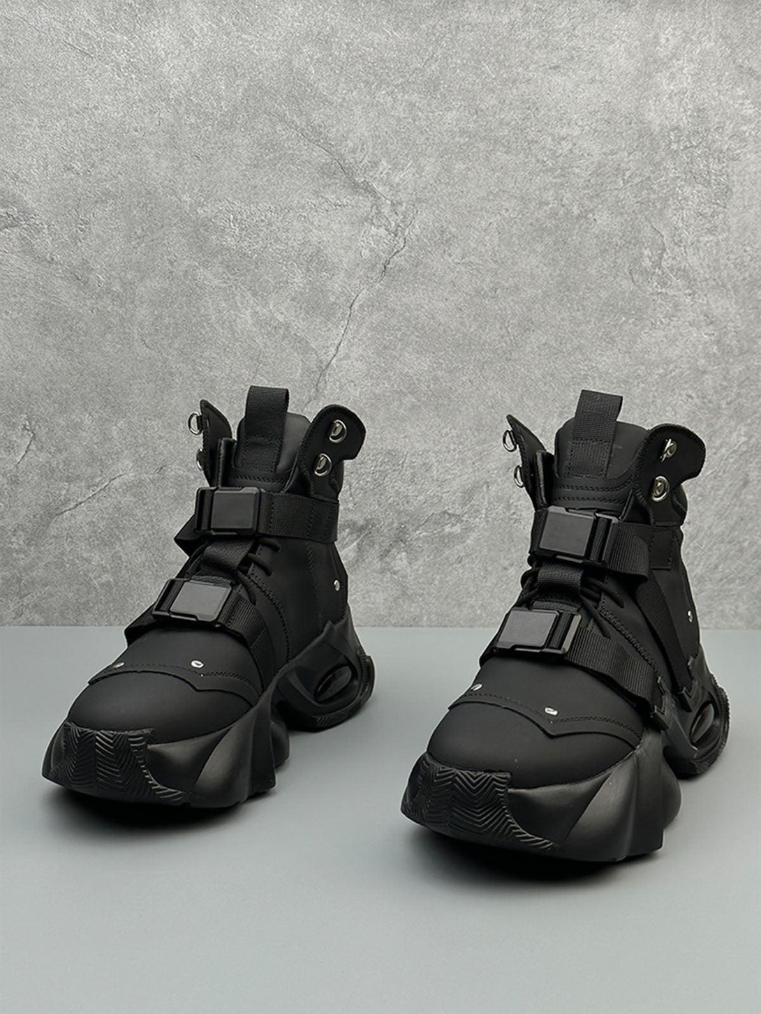 Black dual-strap stealth runner boots by TALISHKO, highlighting an edgy, futuristic look.
