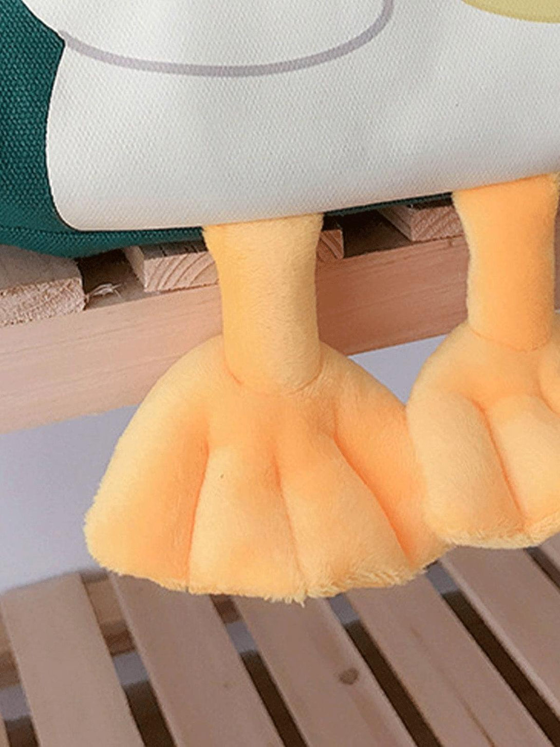 A close-up of TALISHKO's duck canvas bag highlighting the playful plush feet detail.
