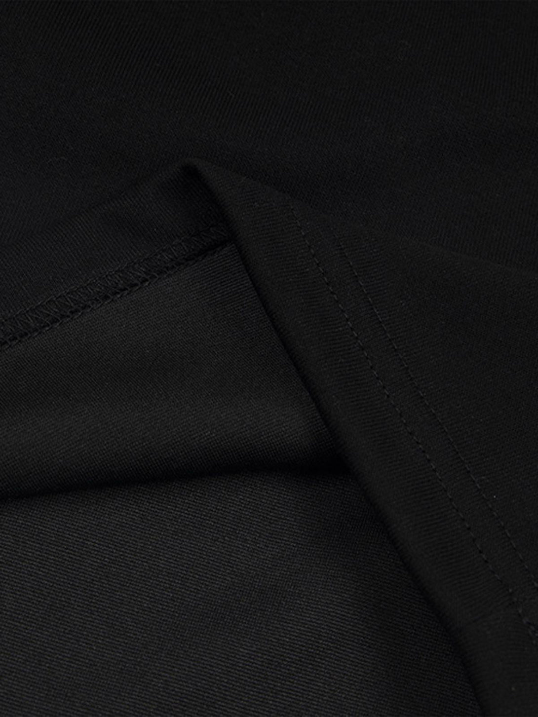 Intricate look at TALISHKO's black shorts, highlighting the smooth fabric and stitching details.