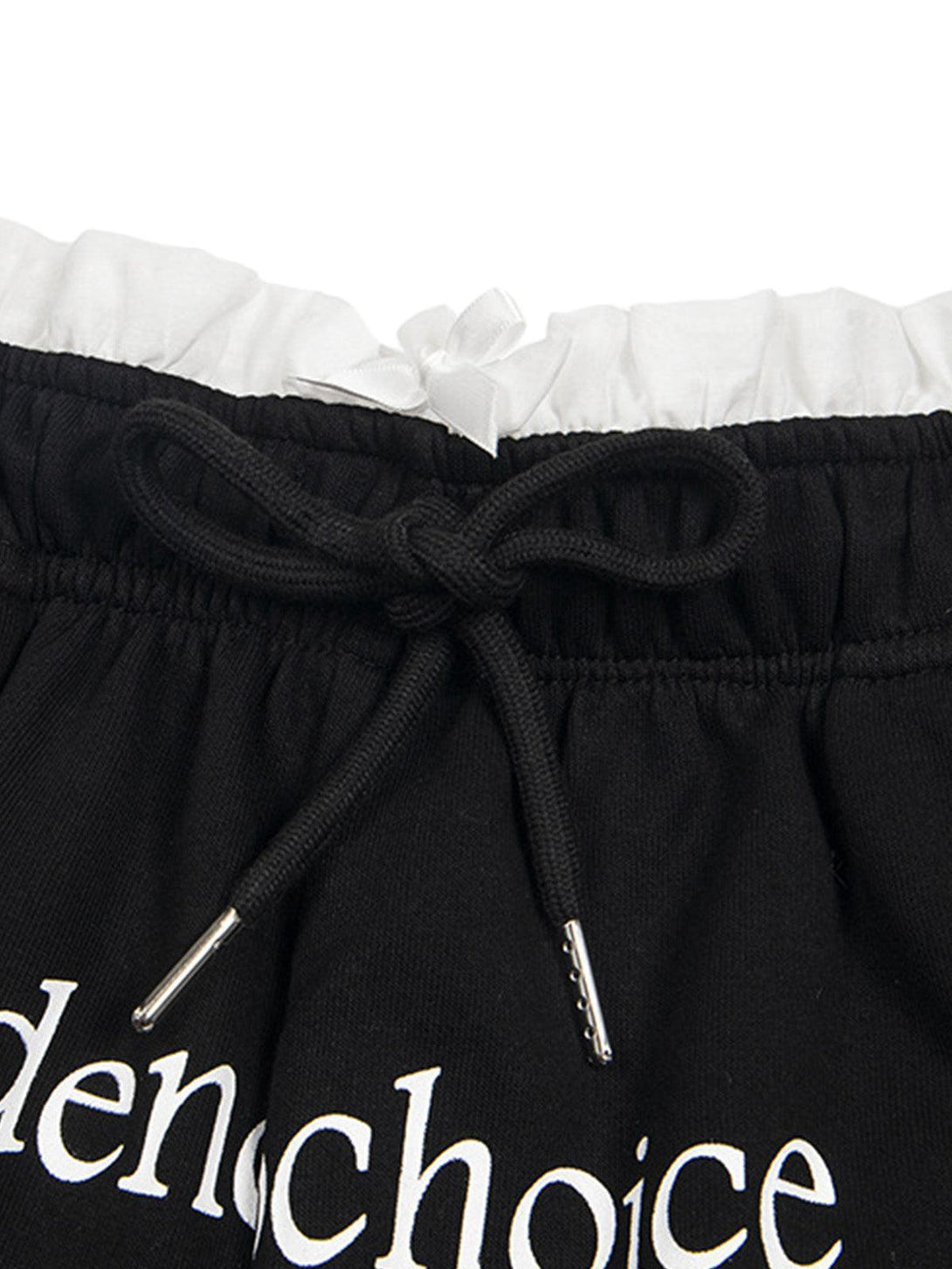 A detailed look at TALISHKO's black shorts, focusing on the double waist and drawstring detail.