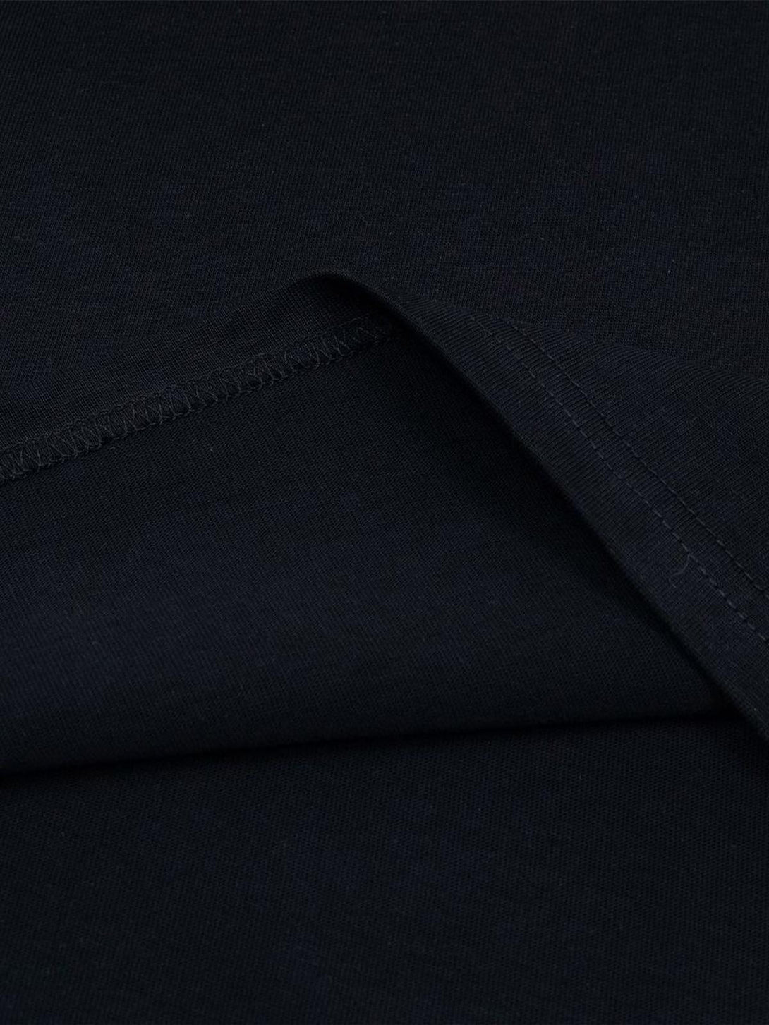 Detailed fabric and stitching of a black oversized T-shirt by TALISHKO, highlighting its texture.