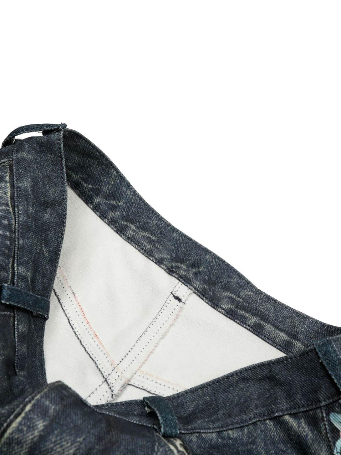 A tight crop highlighting TALISHKO denim shorts' inner stitching and structure details.