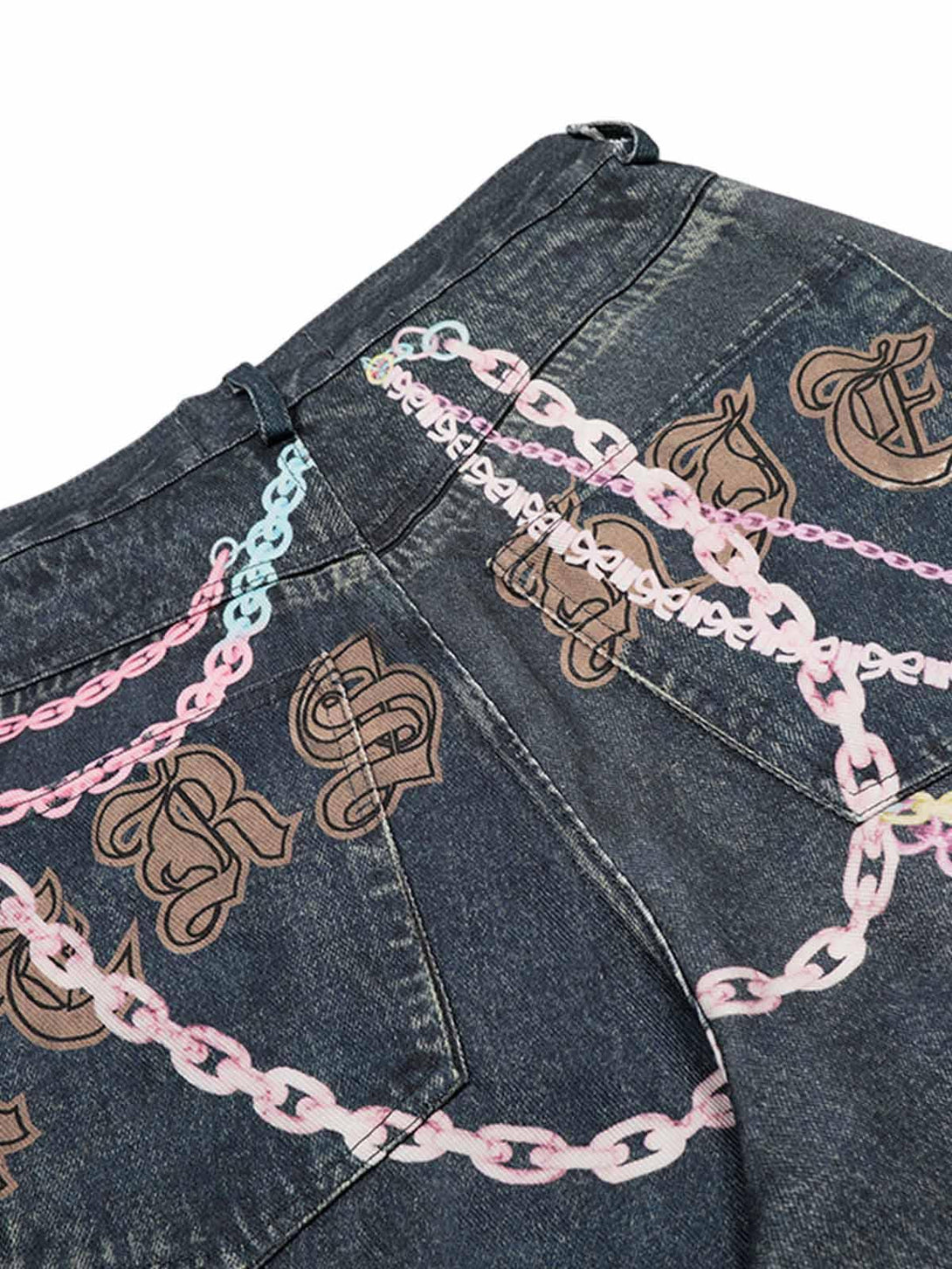 Detailed look at TALISHKO denim shorts with colorful chain and letter accents.