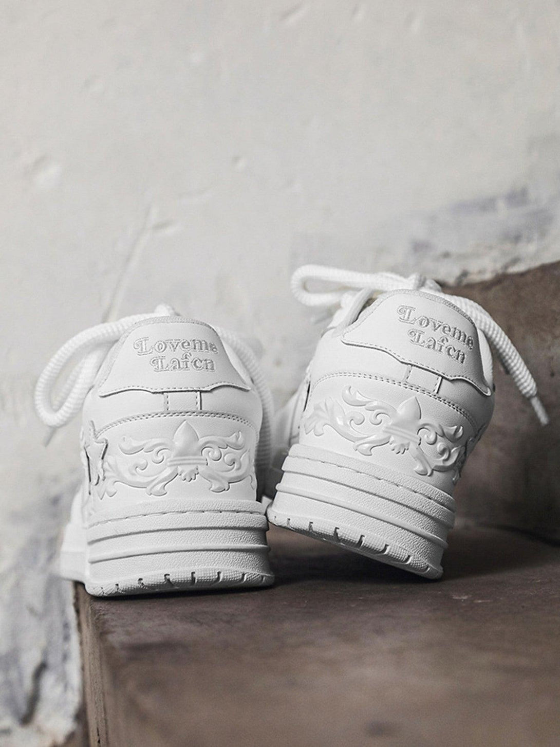 TALISHKO white embossed star board shoes, showcasing intricate back design details.