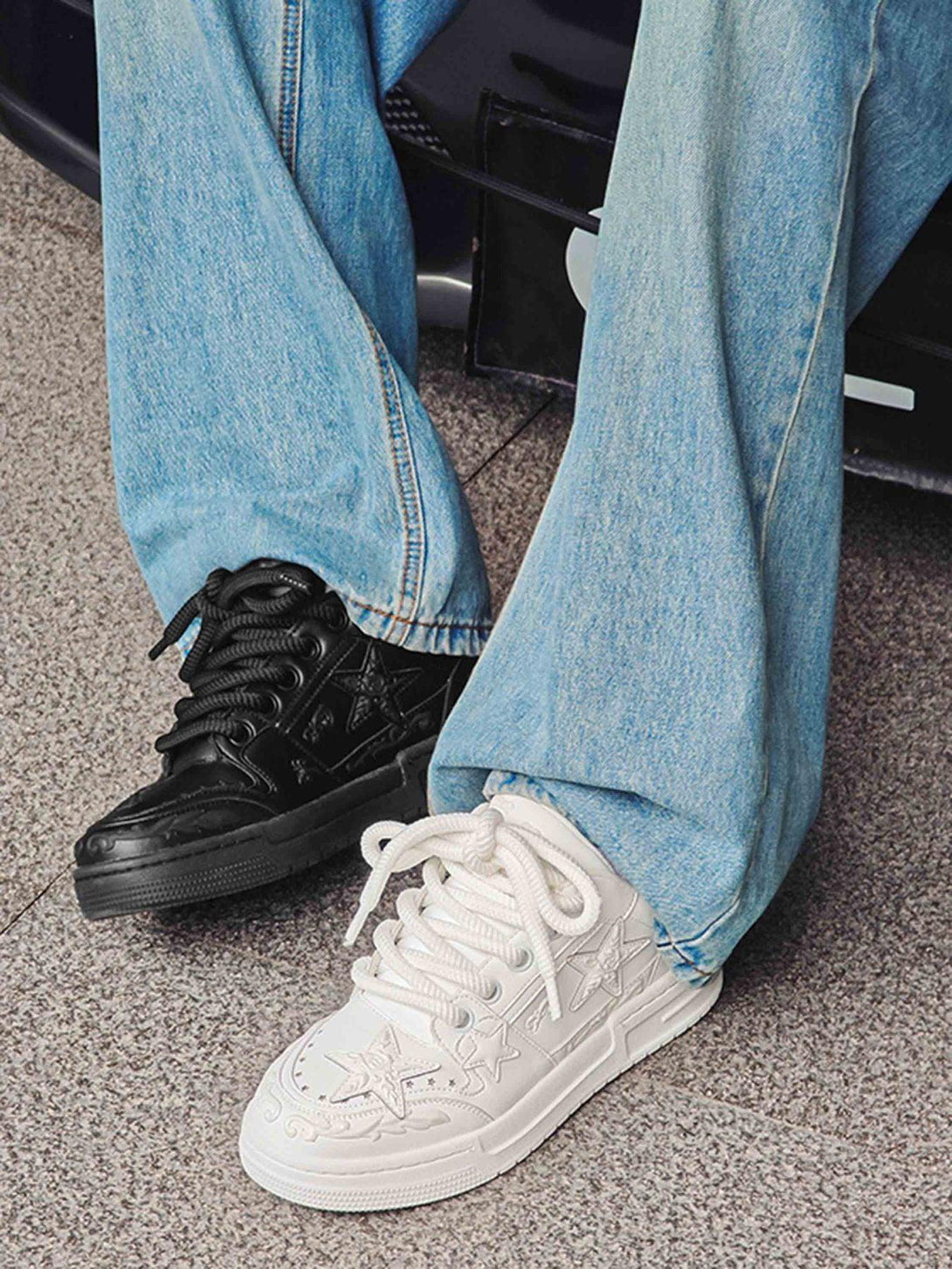 Casual denim paired with mismatched black and white embossed star shoes by TALISHKO for a bold look.