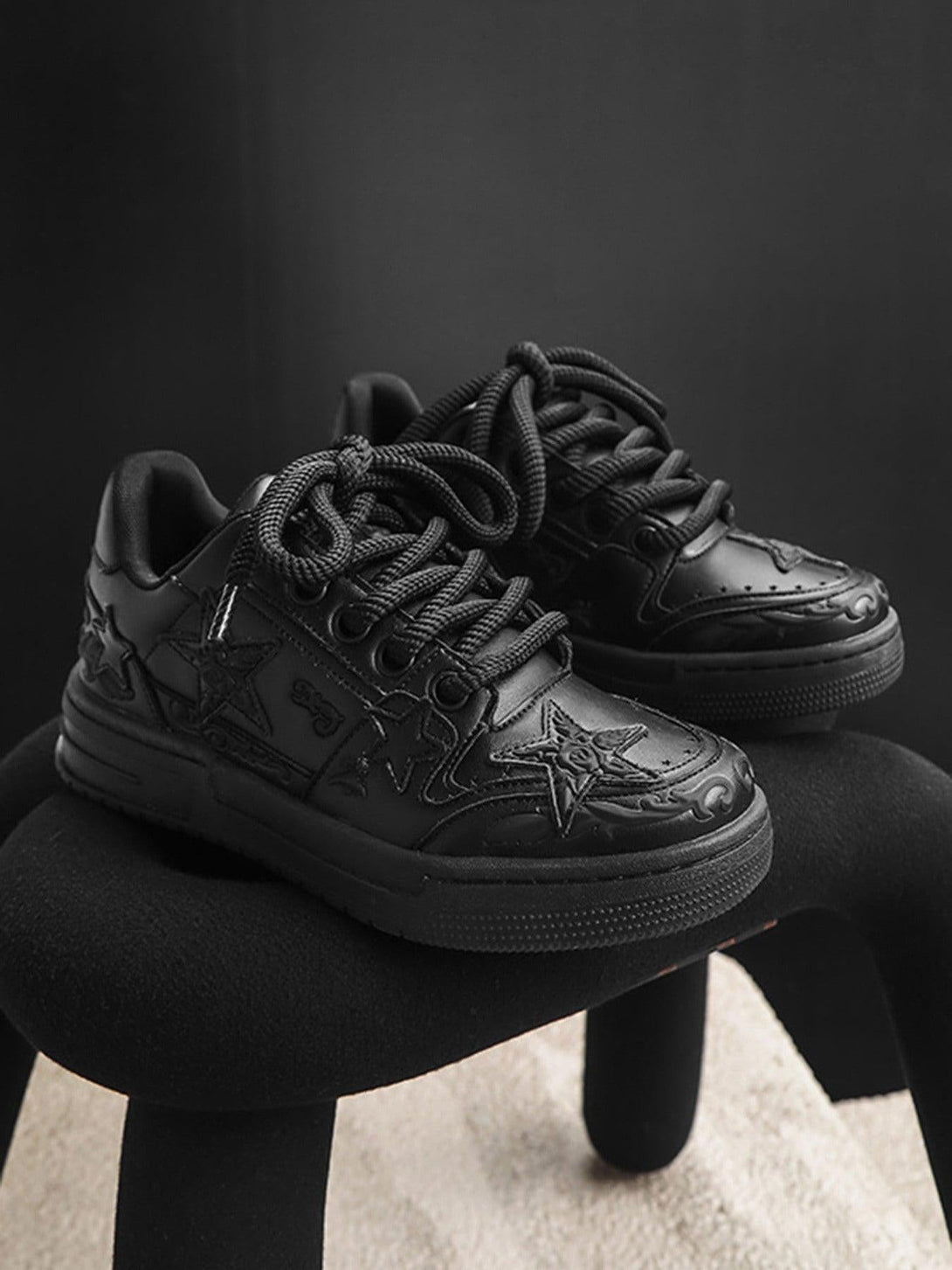 TALISHKO's stylish black casual board shoes with embossed stars, perfect for urban fashion.
