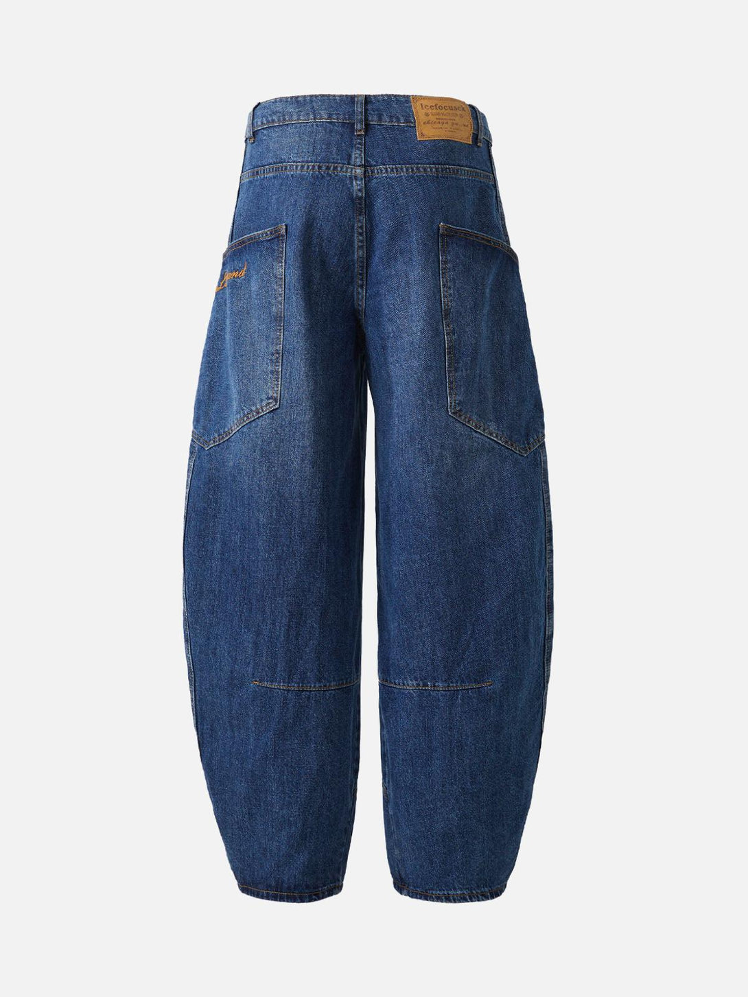 Back view of TALISHKO's blue barrel leg jeans, highlighting embroidered pocket details.