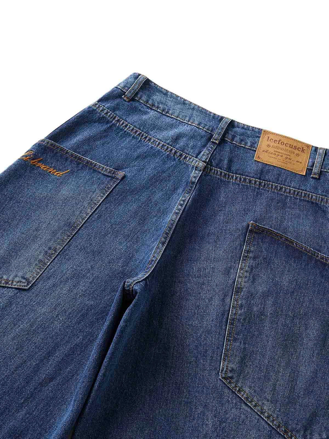 A back view of TALISHKO's embroidered barrel leg jeans, featuring detailed pocket stitching.