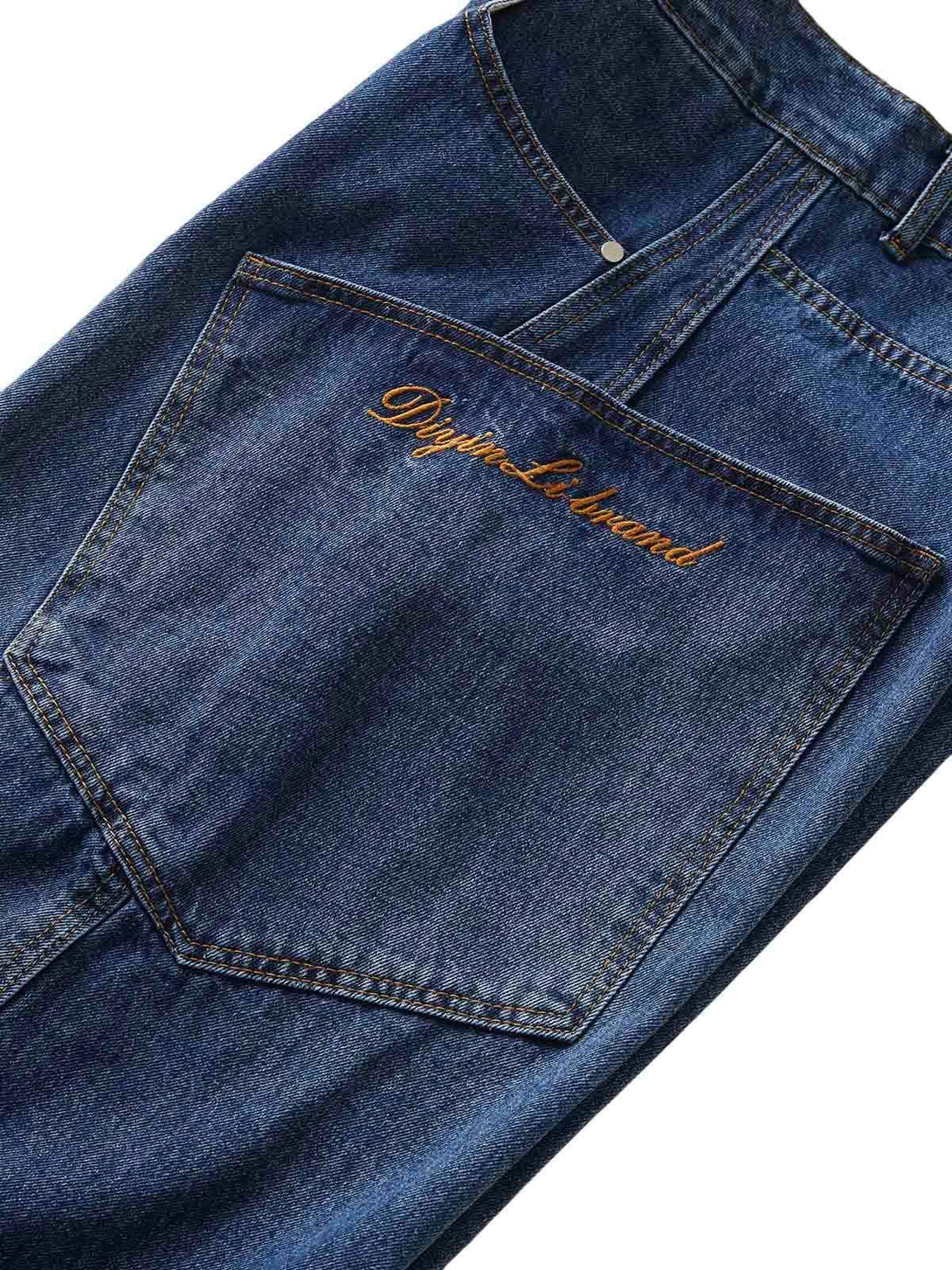 Close-up of TALISHKO's embroidered pocket on barrel leg jeans, highlighting detailed stitching.