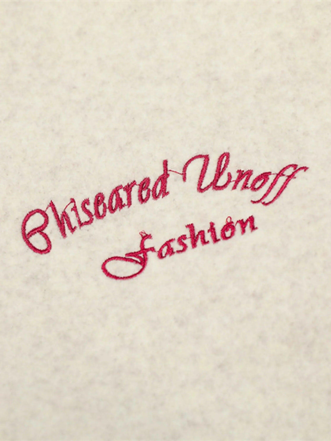 Intricate embroidery detail on a TALISHKO varsity jacket, showcasing elegant stitching.