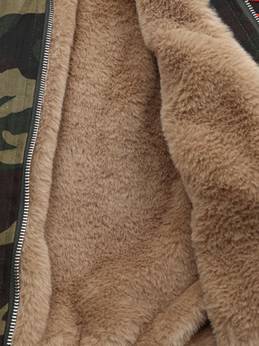 Warm interior of TALISHKO's jacket, highlighting soft fur lining and camouflage fabric edge.