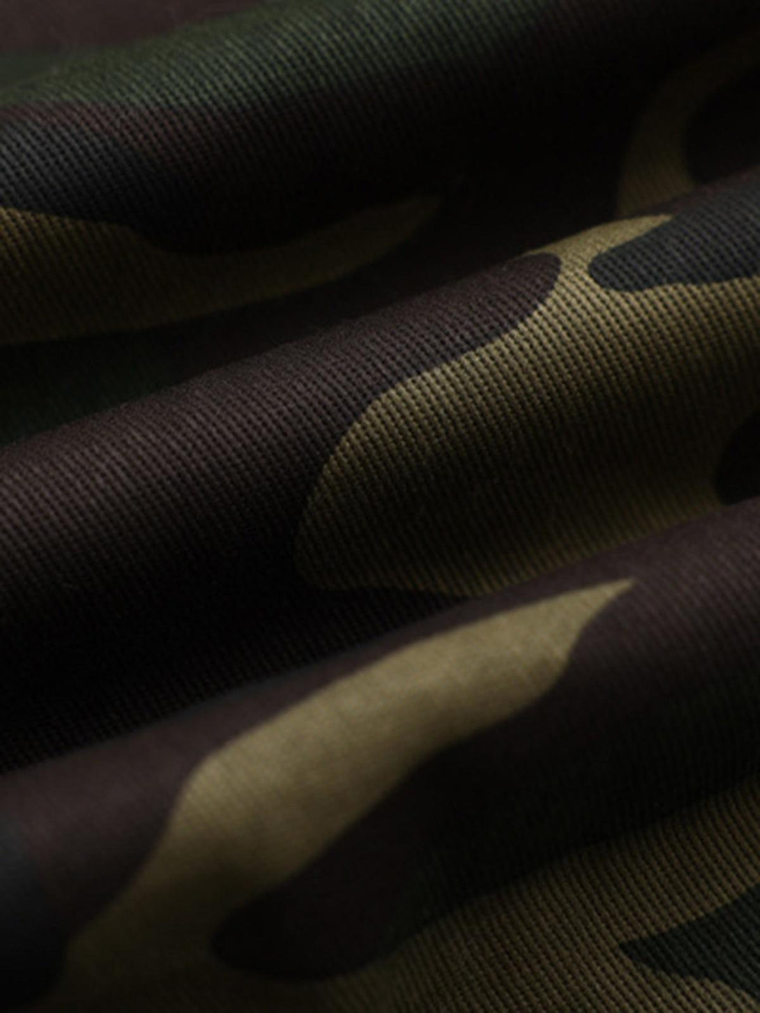Texture and pattern showcased on TALISHKO's camouflage fabric, highlighting intricate design.