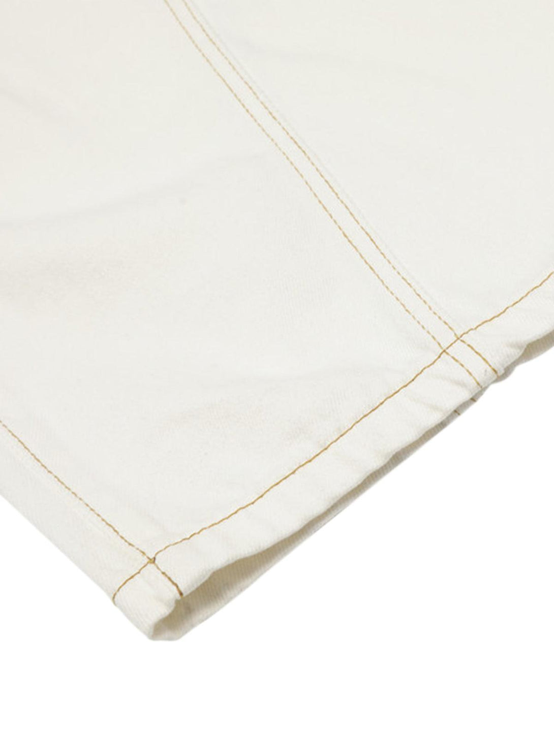 TALISHKO barrel jeans close-up, highlighting white fabric and detailed stitching craftsmanship.