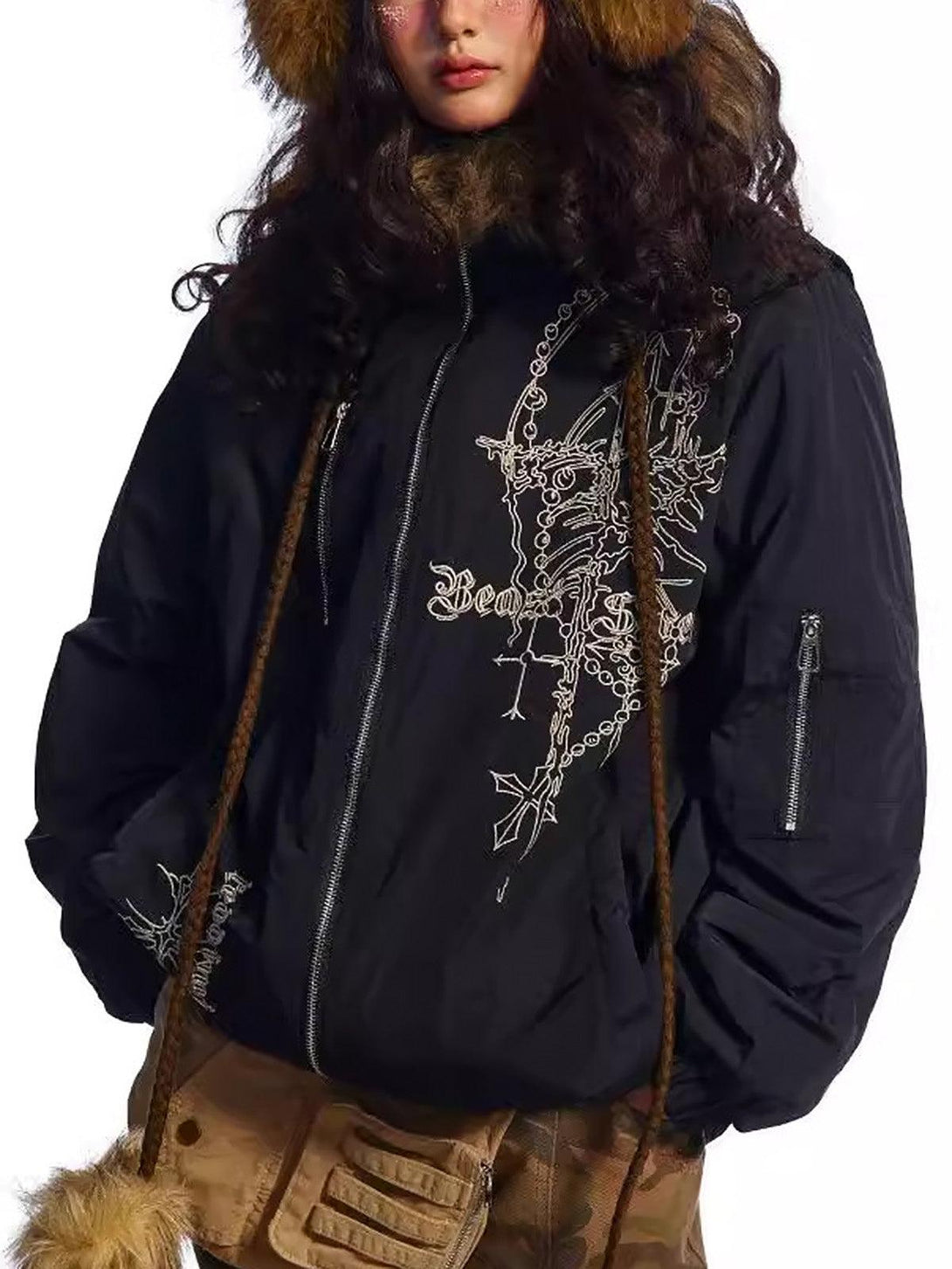 Model wearing TALISHKO's embroidered black quilted jacket with a fur hood, showcasing unique style.