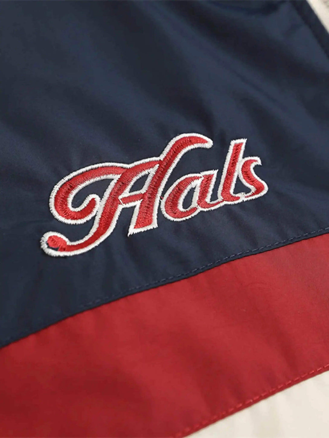 Intricate look at TALISHKO's embroidered lettering on a cotton jacket with contrasting colors.