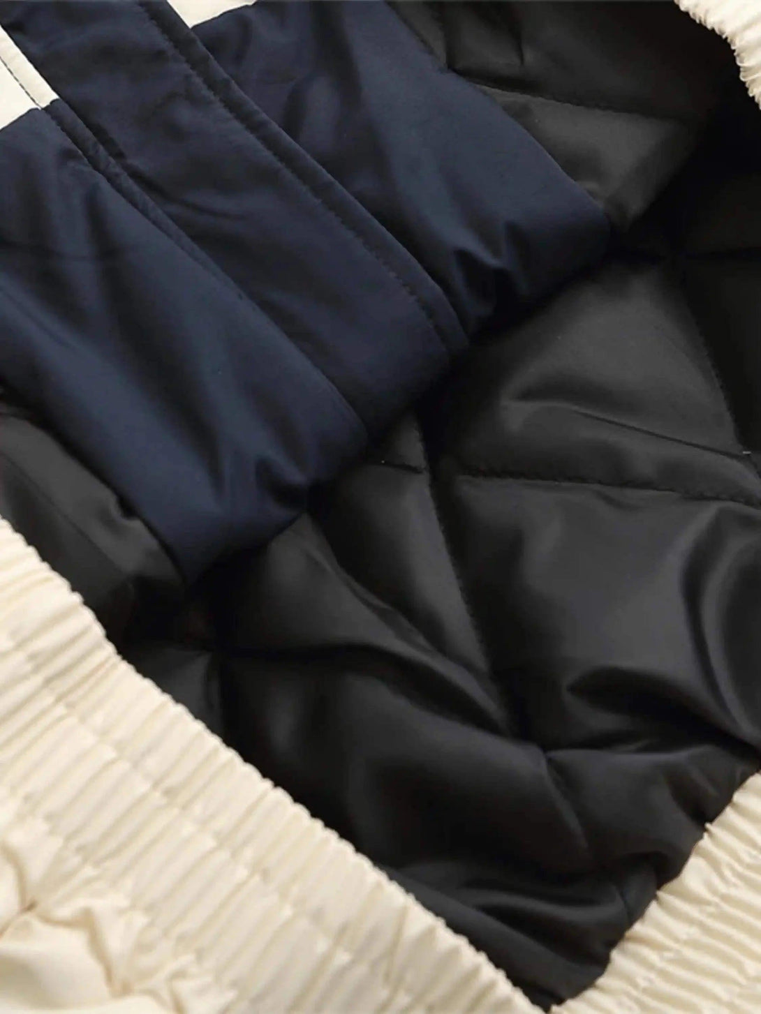 Detailed fabric and stitching inside TALISHKO's cotton jacket, highlighting inner padding.