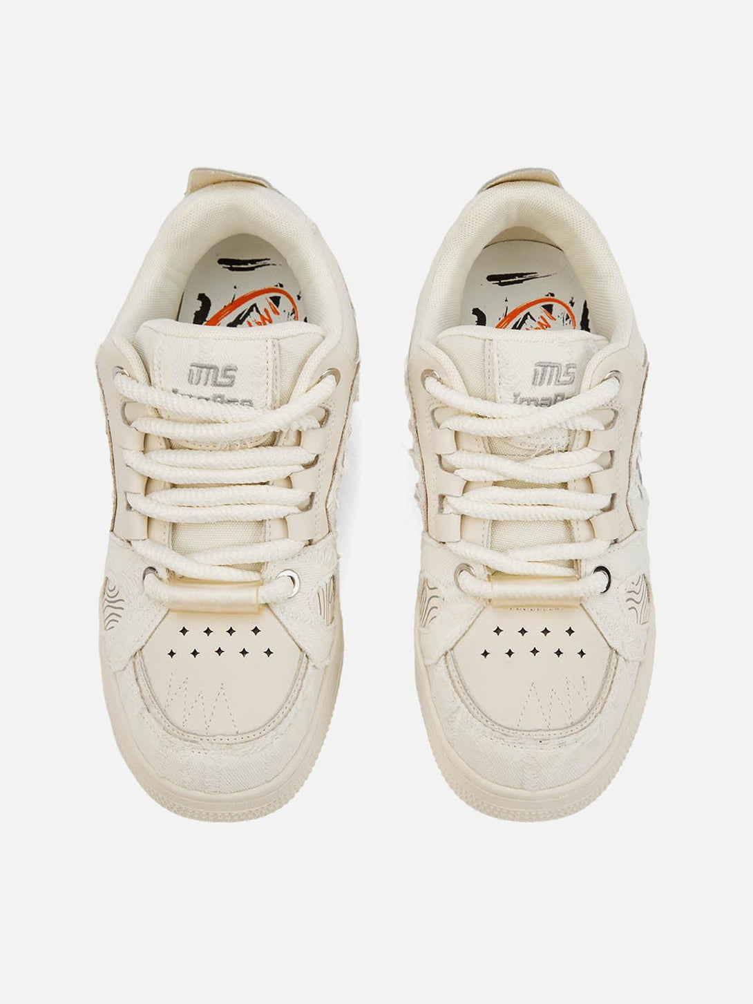 Top view of embroidered letter shoes by TALISHKO, featuring unique lace and perforation details.