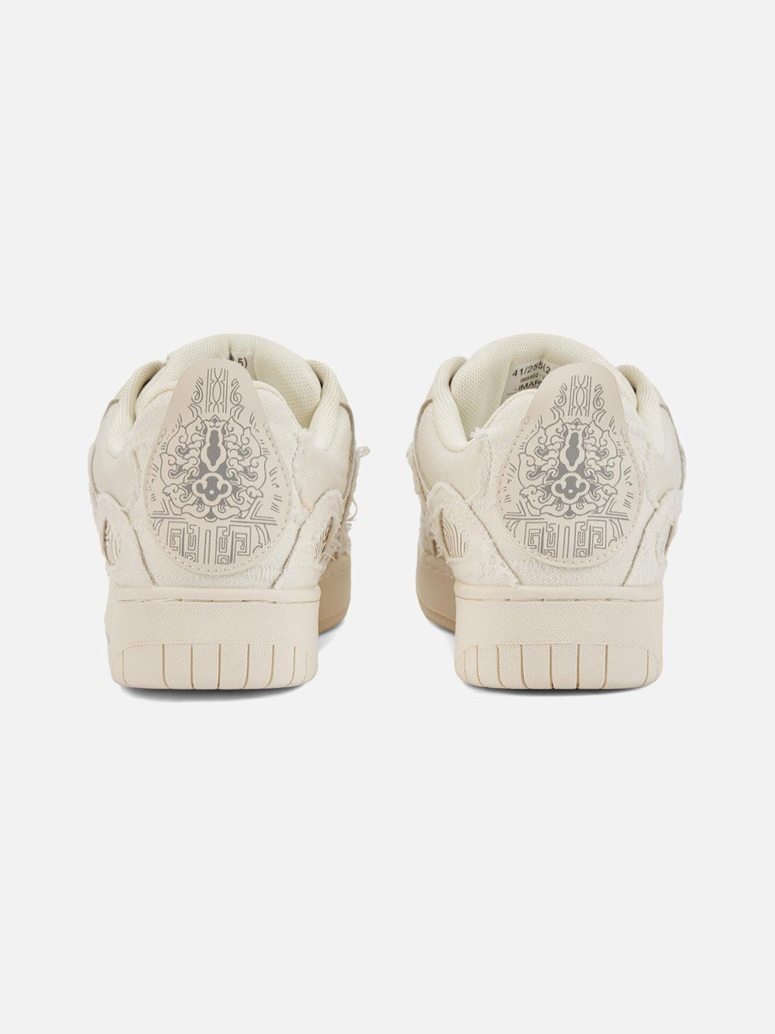 Back view of cream shoes by TALISHKO, featuring detailed heel embroidery and unique patterns.