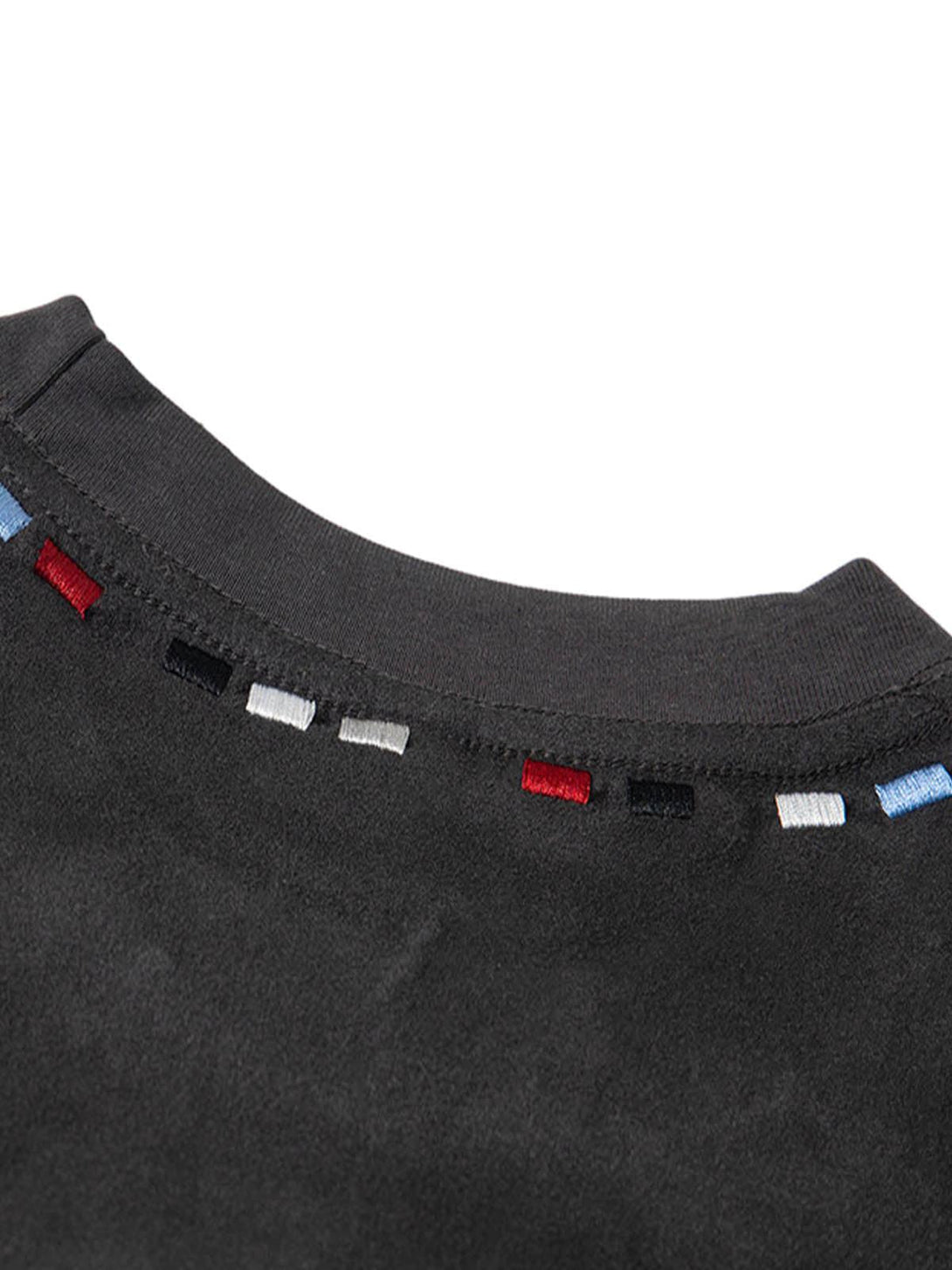 Intricate embroidery detail around the neckline of TALISHKO's oversized T-shirt.