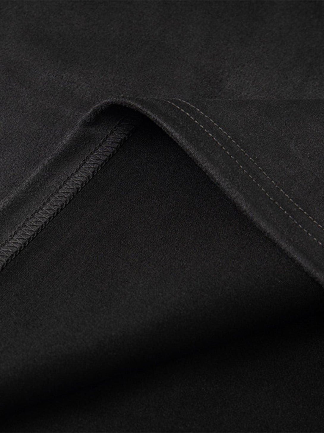 Detailed fabric and stitching of TALISHKO's oversized T-shirt in black.