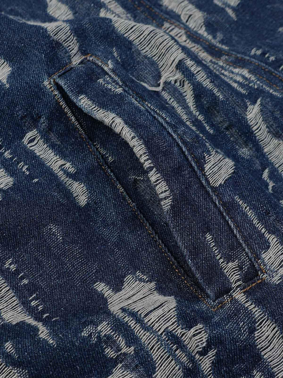 A tight crop highlighting the textured pattern on TALISHKO's embroidered washed denim hoodie.