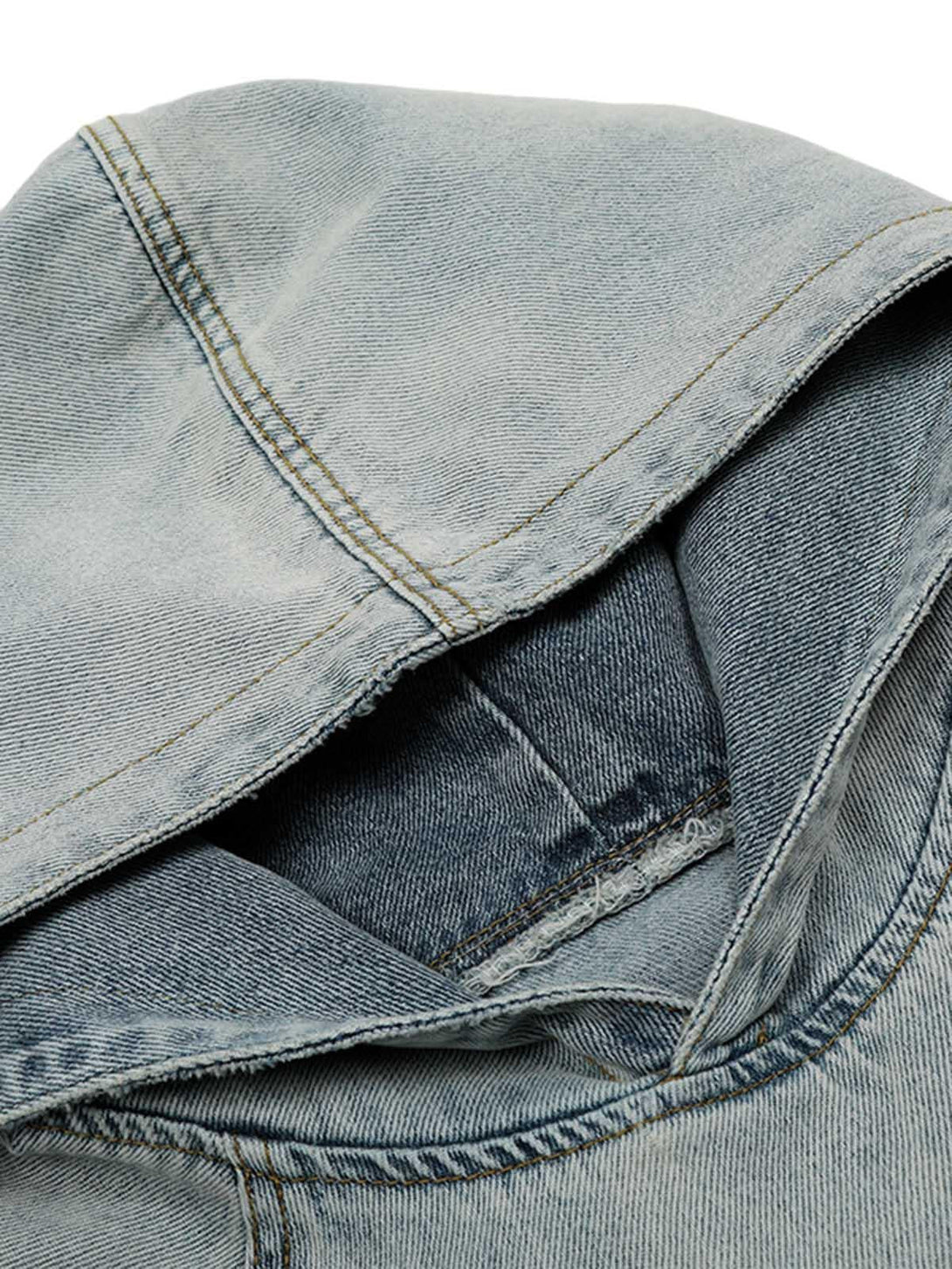 Intricate look at the washed and distressed denim fabric by TALISHKO, highlighting texture.