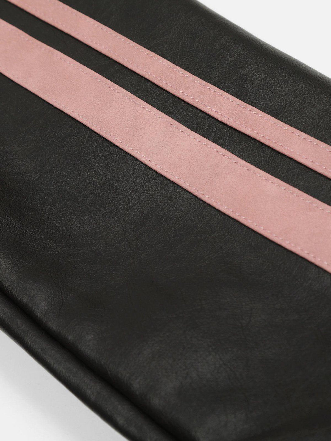 Focusing on the TALISHKO jacket, pink stripes add contrast to the black faux leather texture.